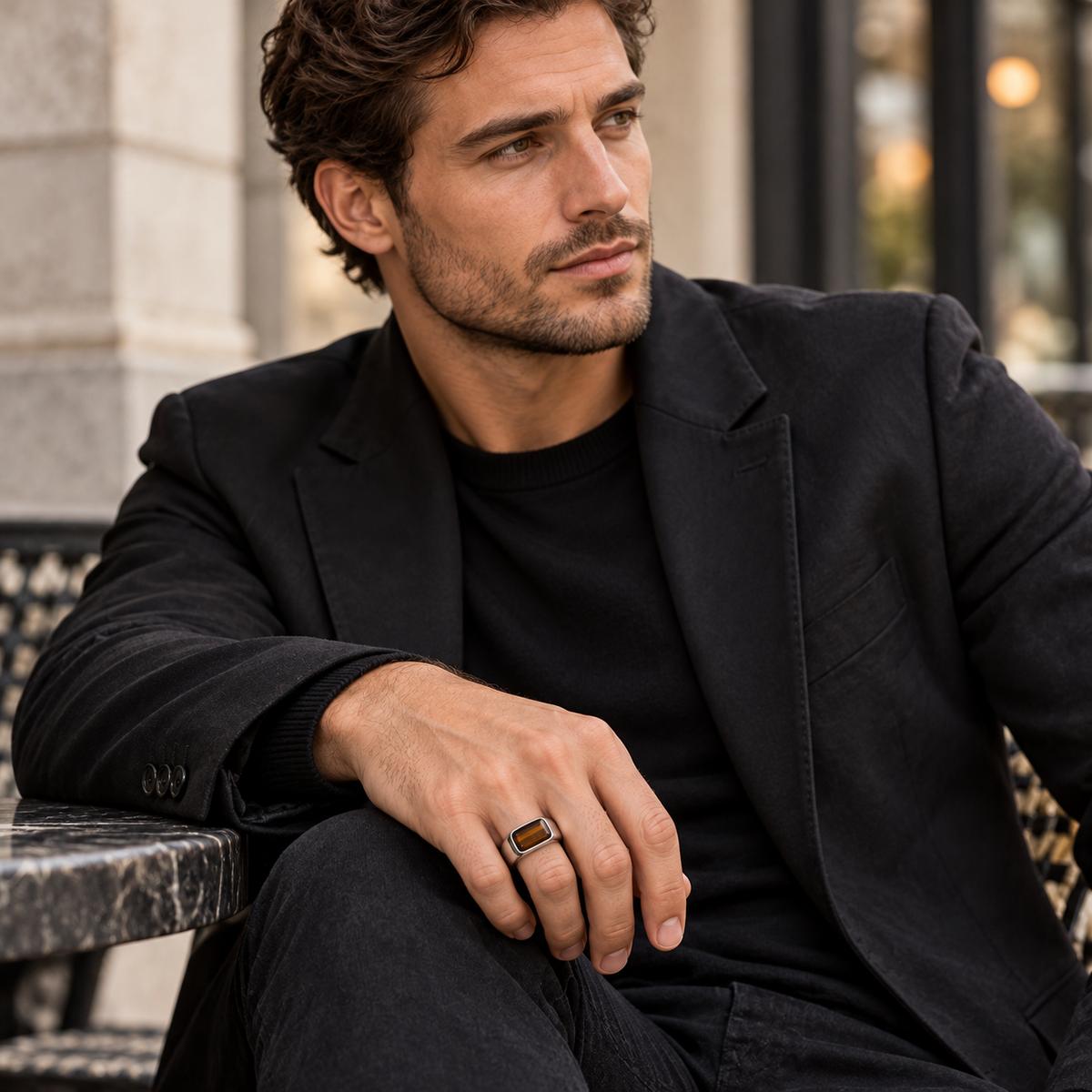 Model wearing modern minimalist tiger eye signet ring on finger
