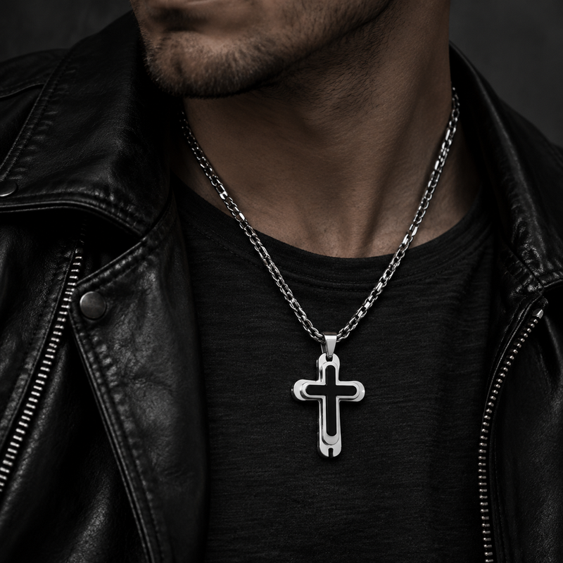 Model wearing men's rounded steel cross necklace with black inlay on leather biker jacket
