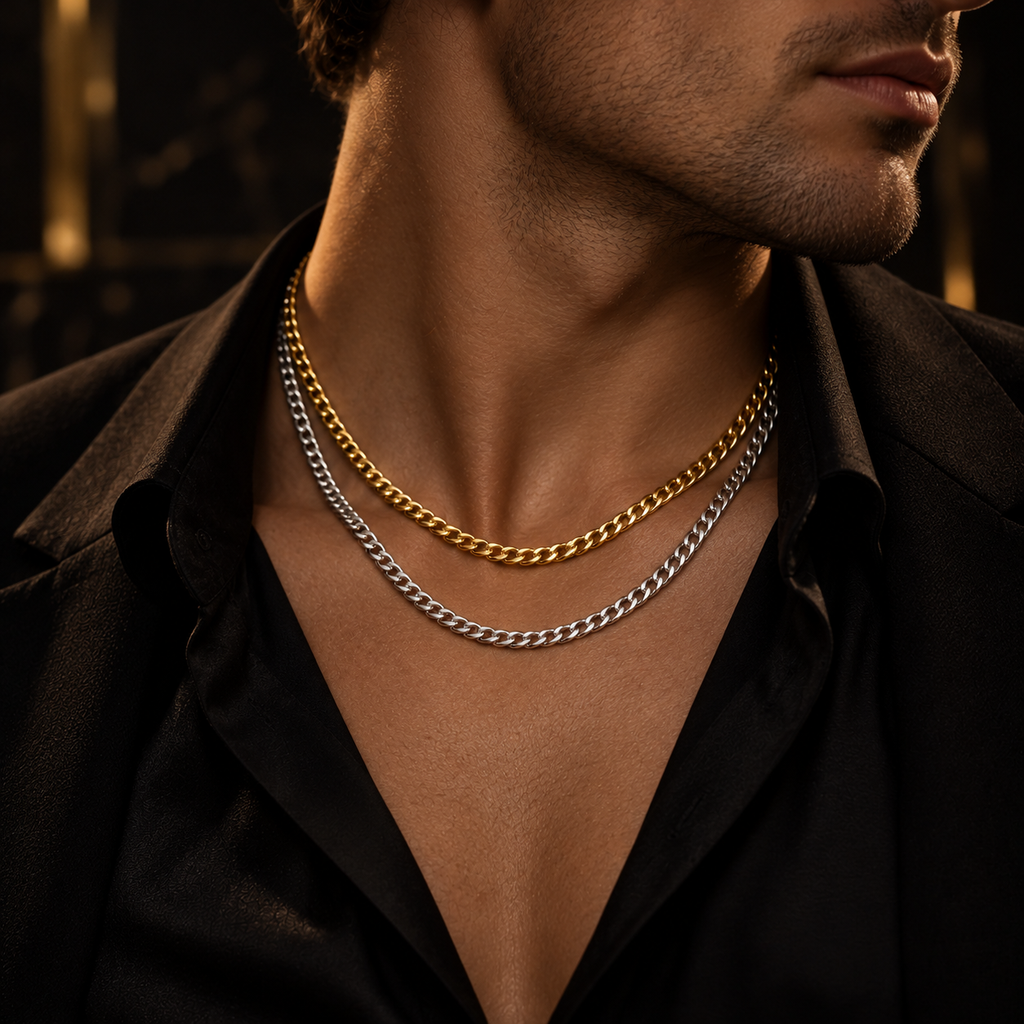 Model wearing layered gold and silver Cuban link chain necklaces with black suit
