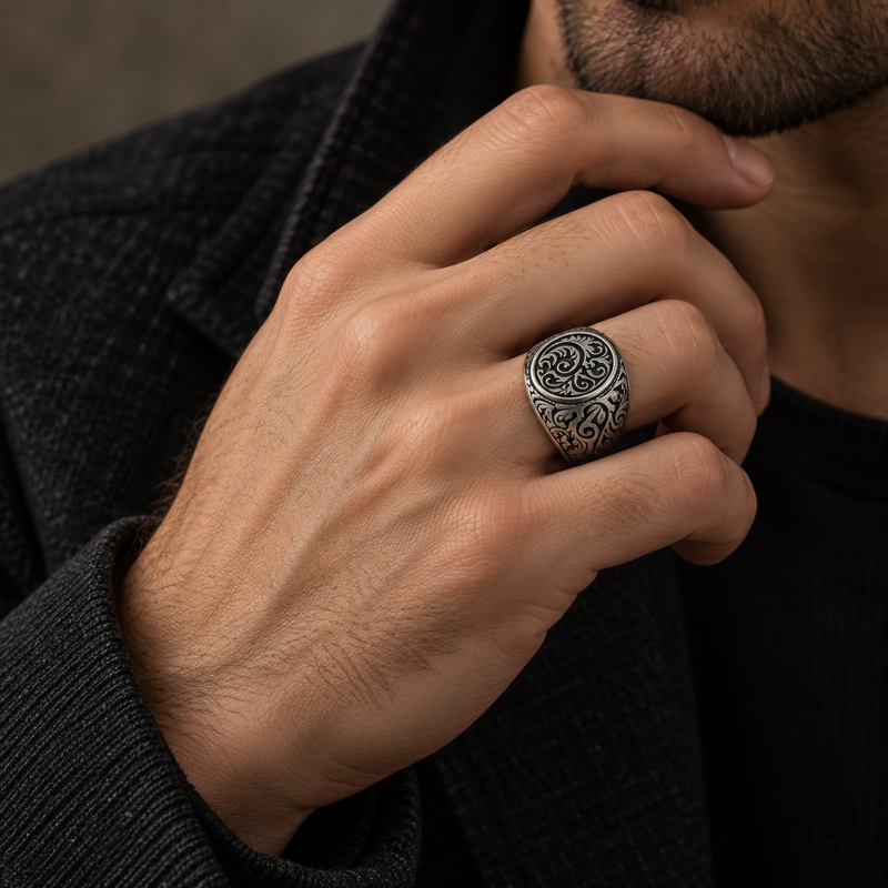 Model wearing a vintage engraved floral stainless steel signet ring on finger
