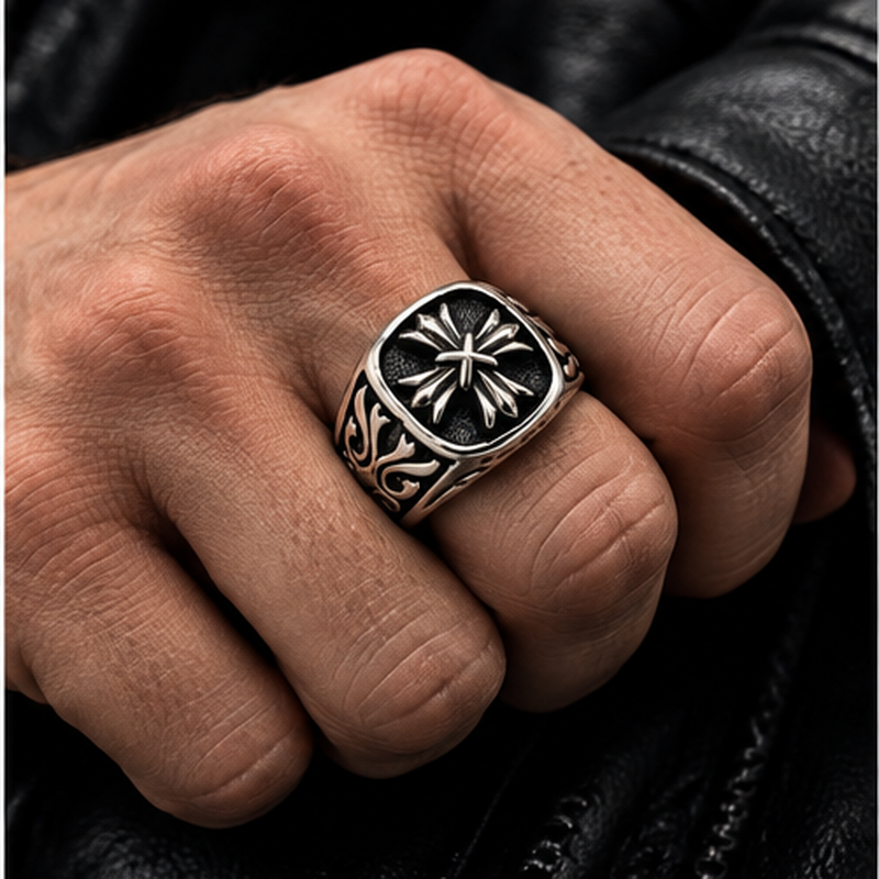 Male hand wearing Men's Gothic Fleur Cross Signet Ring paired with black leather jacket