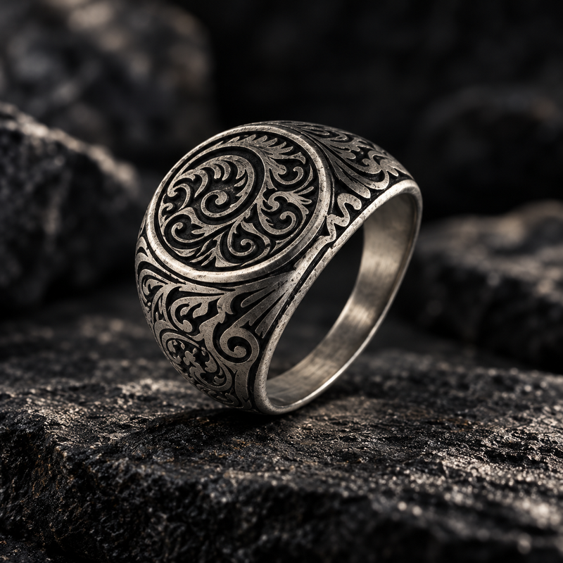 Angled view of vintage baroque scrollwork stainless steel ring
