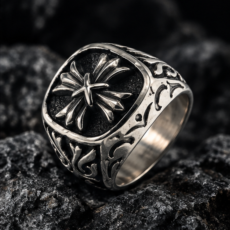 Vintage stainless steel floral cross signet ring displayed on black volcanic stone