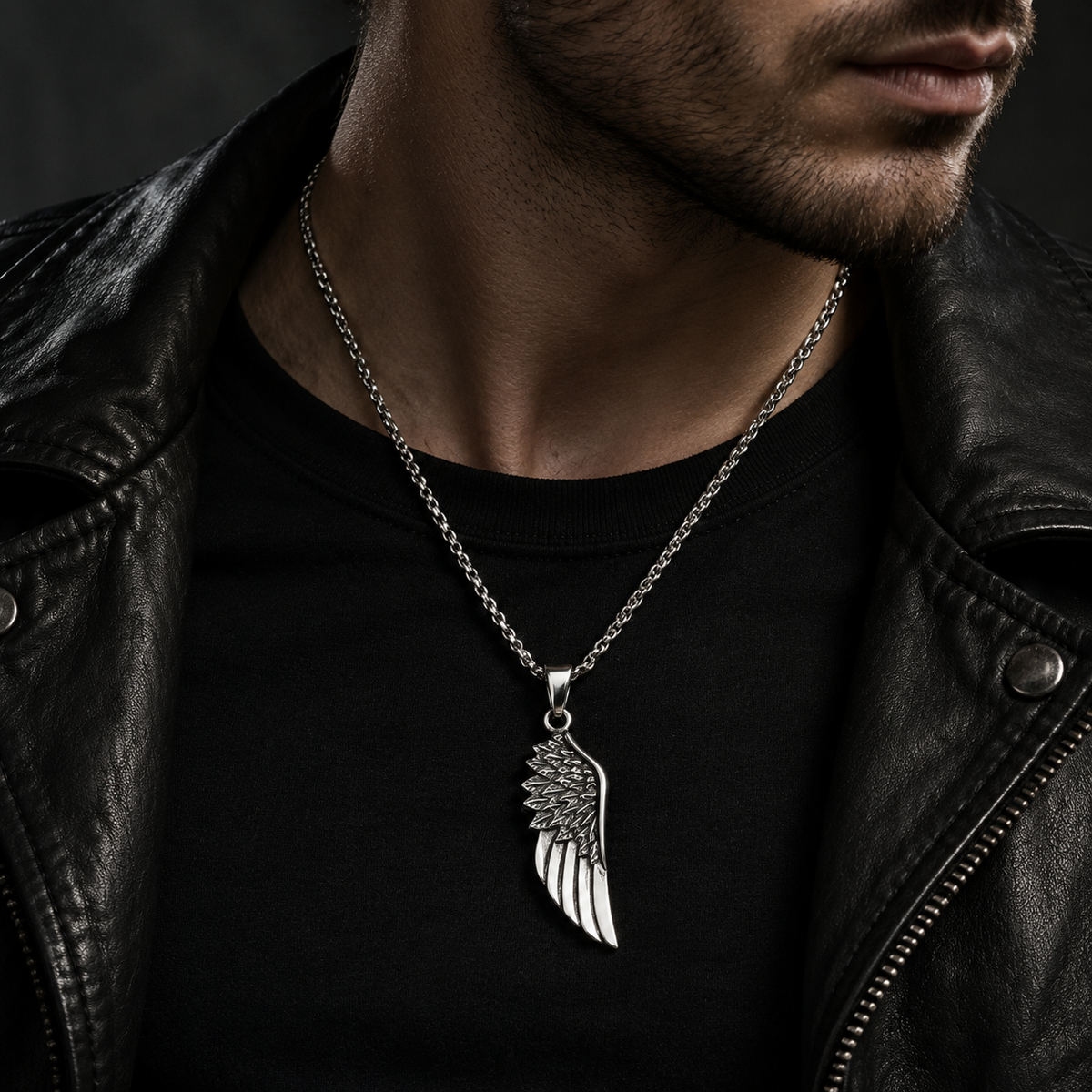 Model wearing men's silver angel wing pendant necklace with black leather biker jacket
