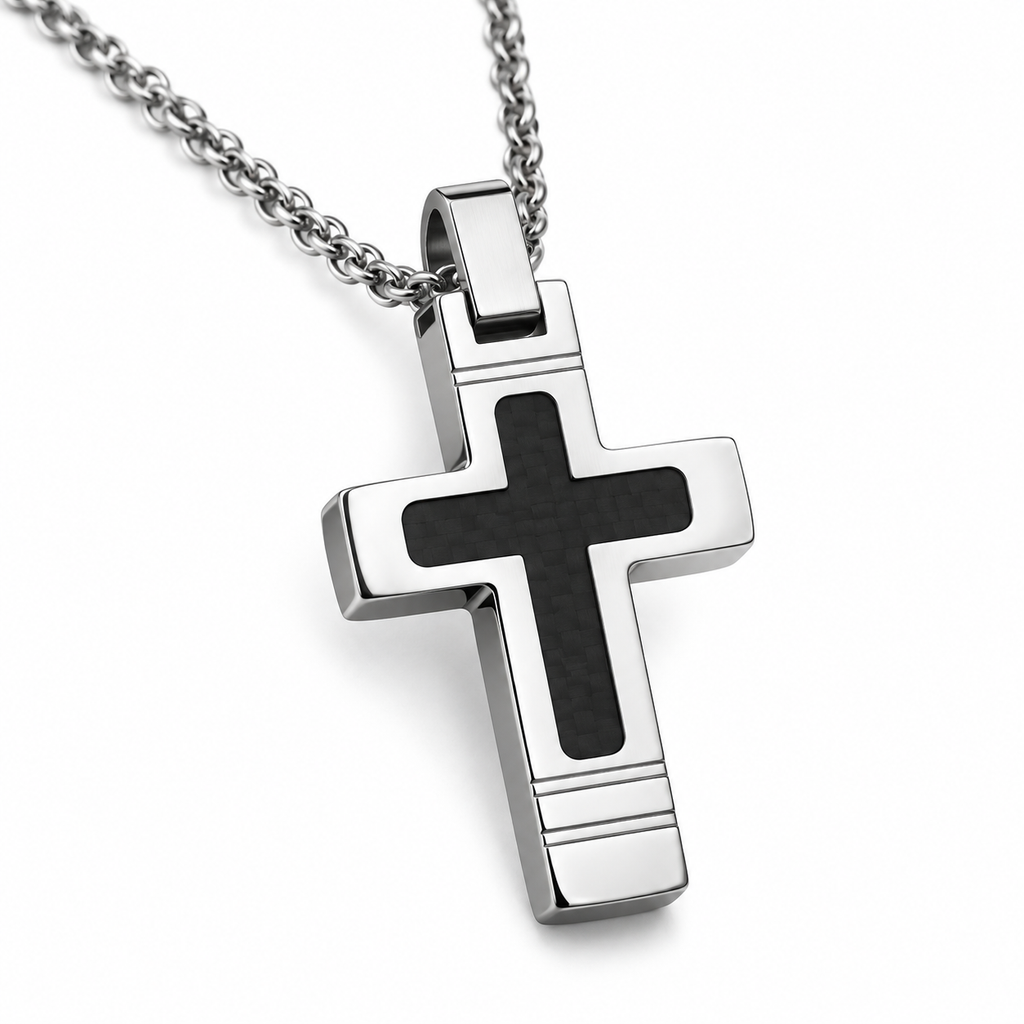 Angled studio close-up of men's beveled stainless steel black cross pendant on white background
