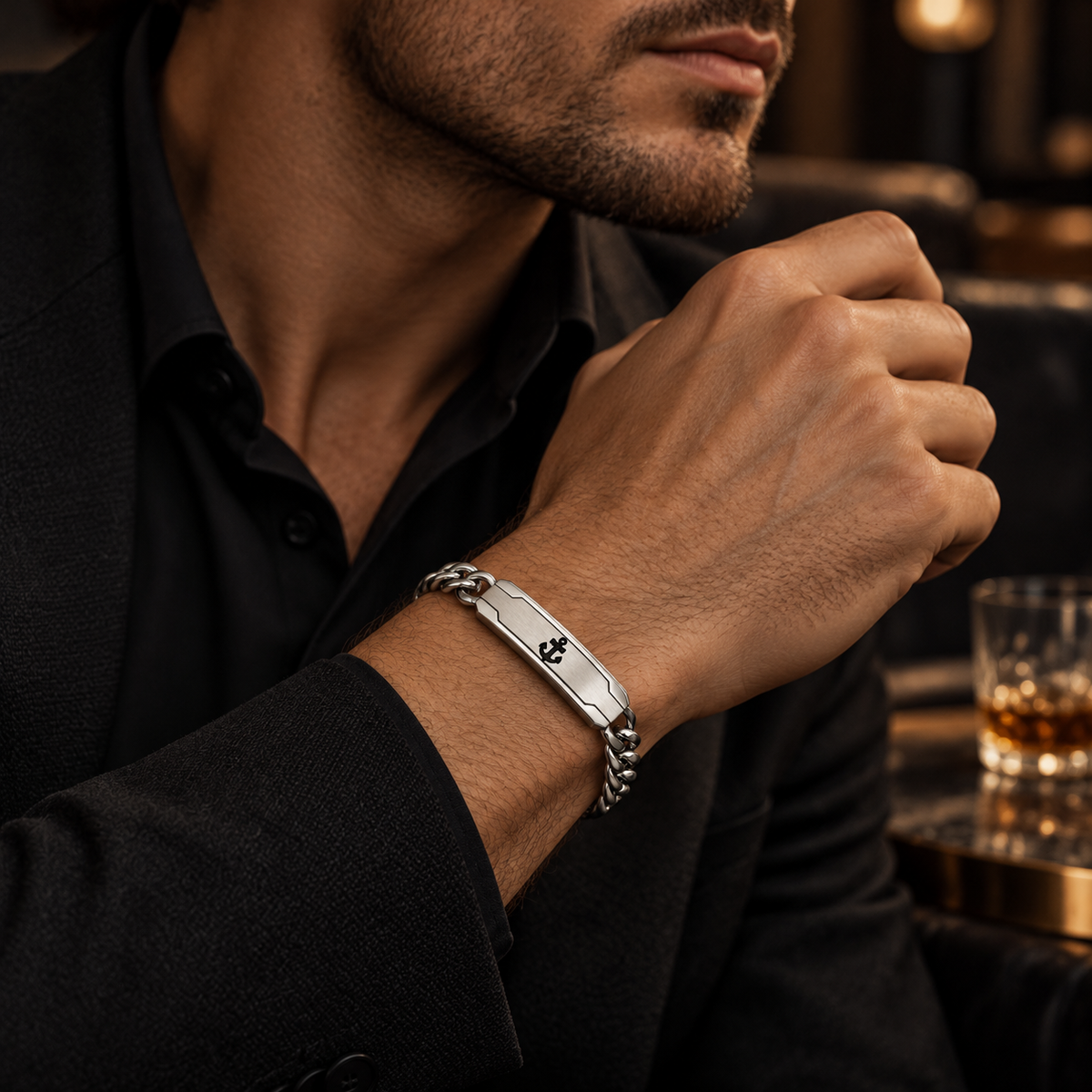 Model wearing men's stainless steel anchor ID bracelet with formal black suit
