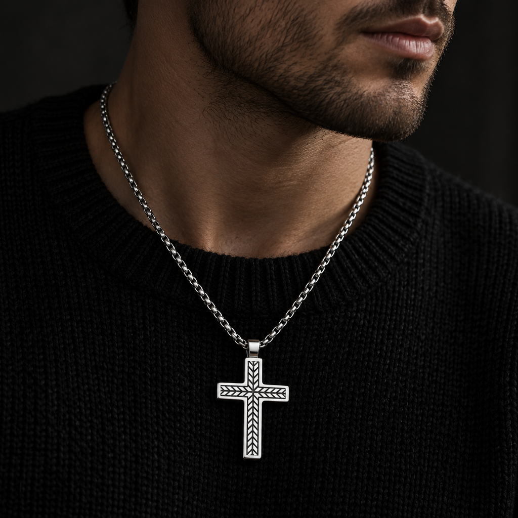 Model wearing men's silver geometric arrow cross pendant on black knit sweater
