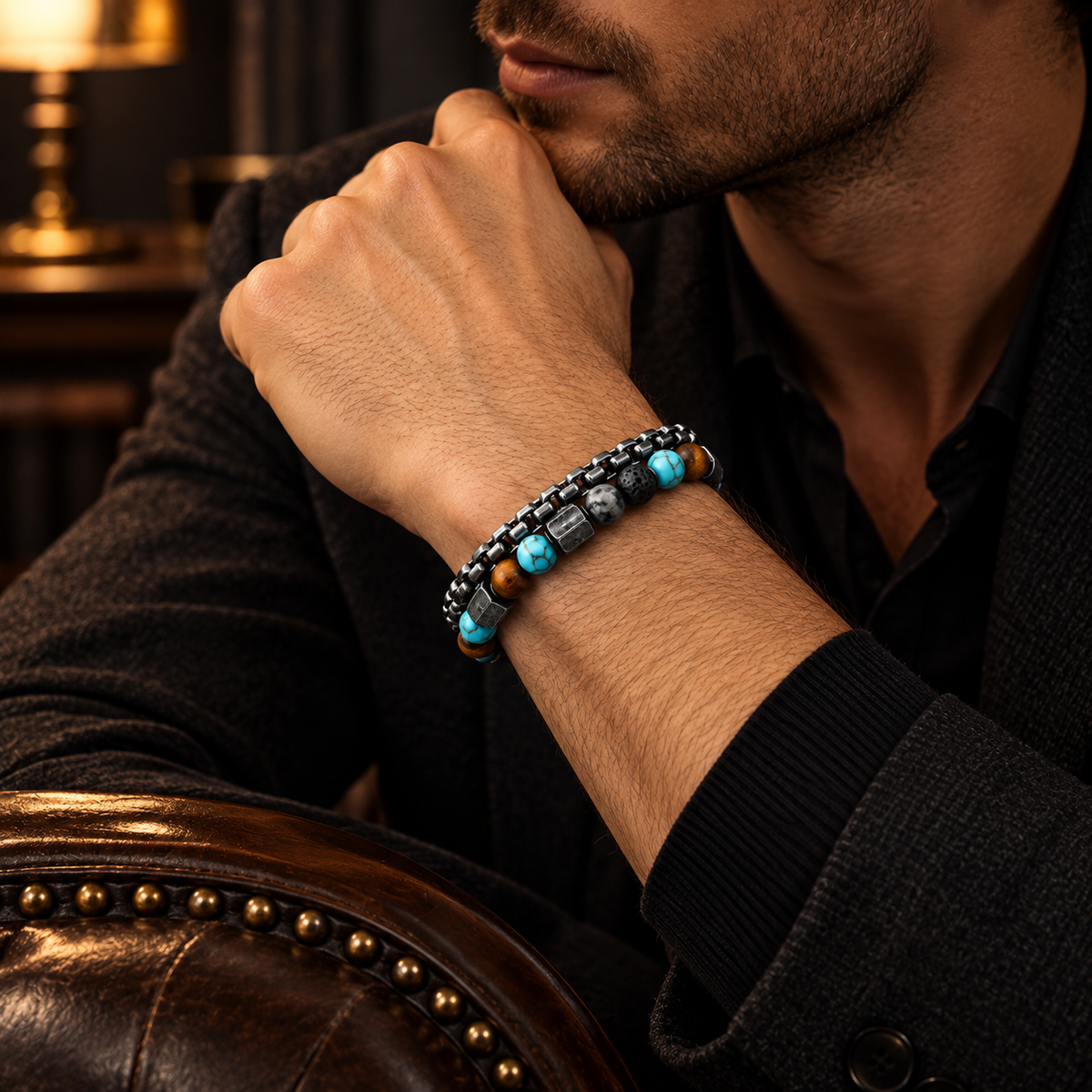 Model wearing men's turquoise and tiger eye beaded stainless steel bracelet with dark suit jacket