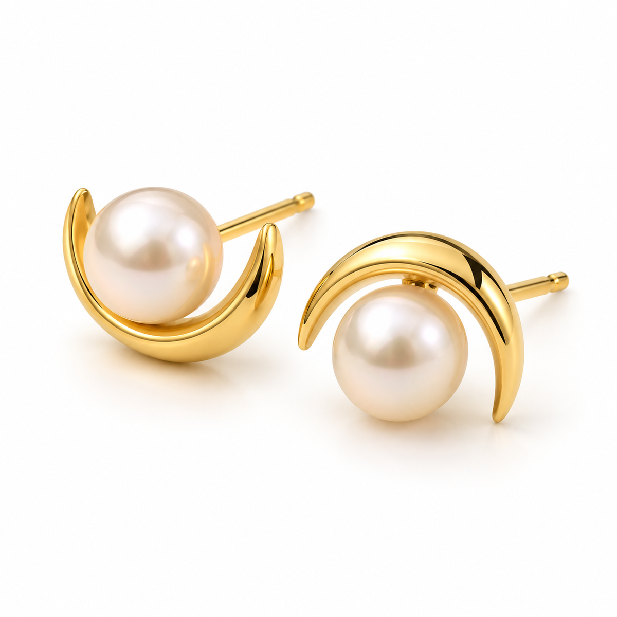 Pair of 18K gold plated crescent moon and freshwater pearl stud earrings on white background
