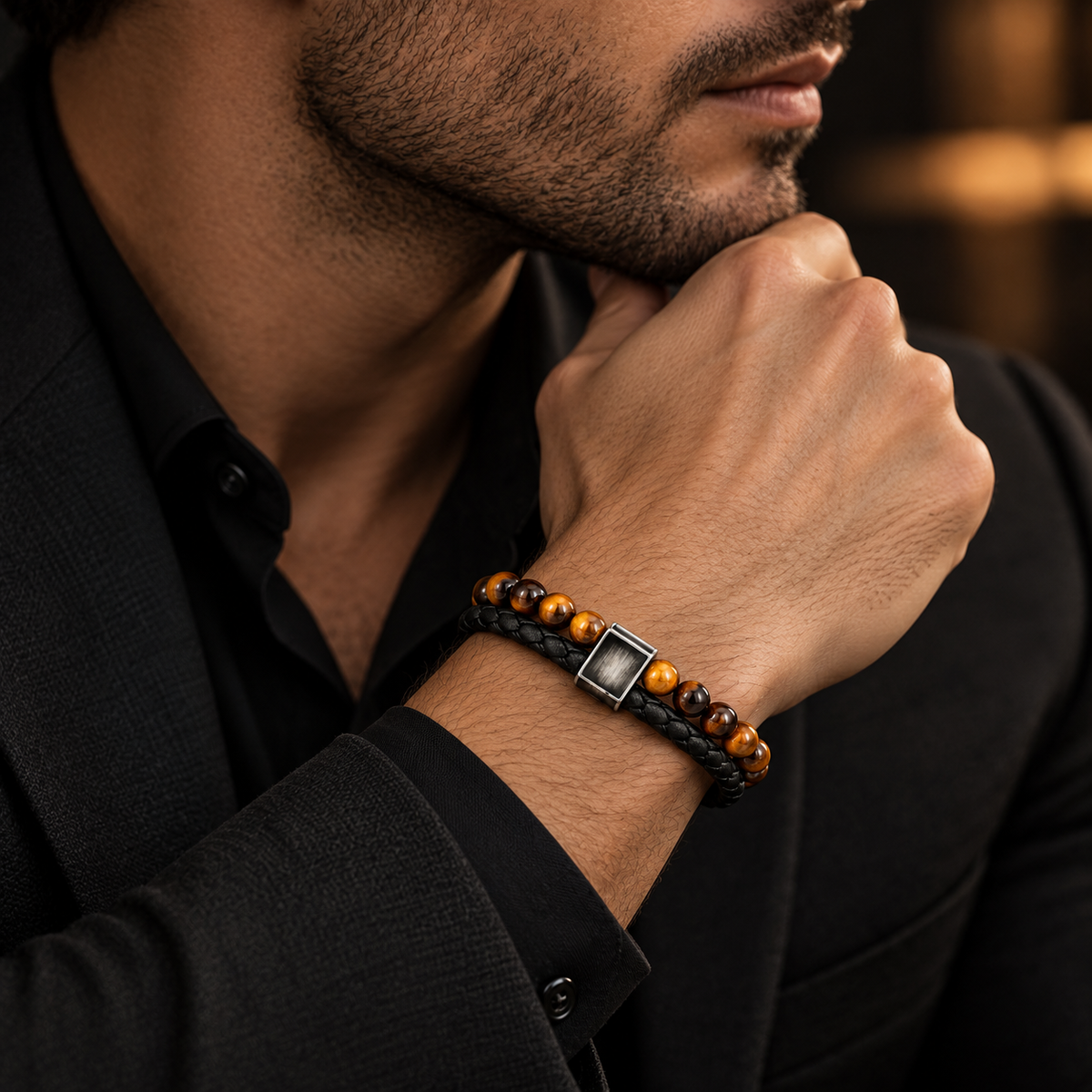 Male wrist wearing double-strand tiger eye beaded bracelet paired with black tailored blazer
