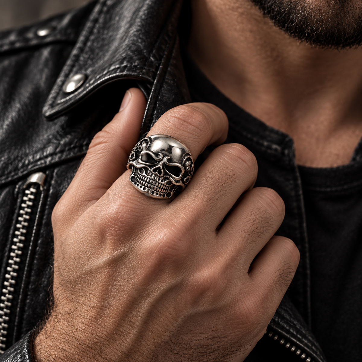 Model wearing heavy carved stainless steel skull statement ring on hand

