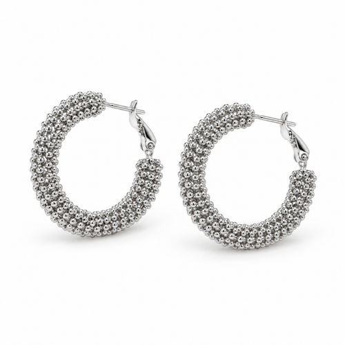 Pair of chunky silver beaded caviar texture hoop earrings on white background
