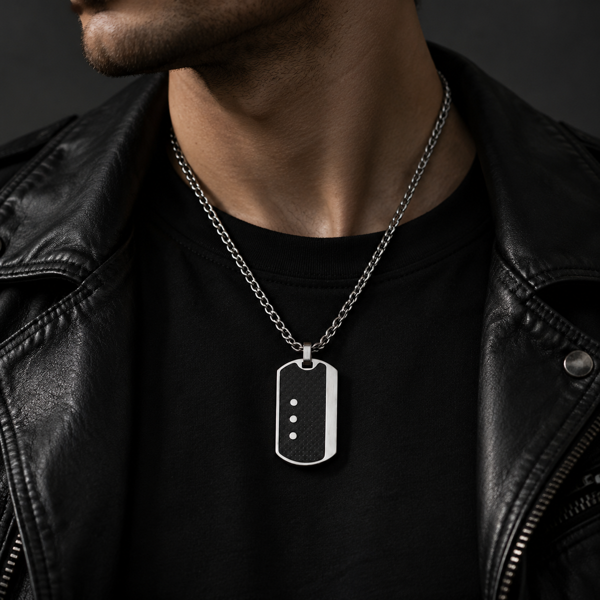 Model wearing men's carbon fiber dog tag pendant necklace with black leather biker jacket
