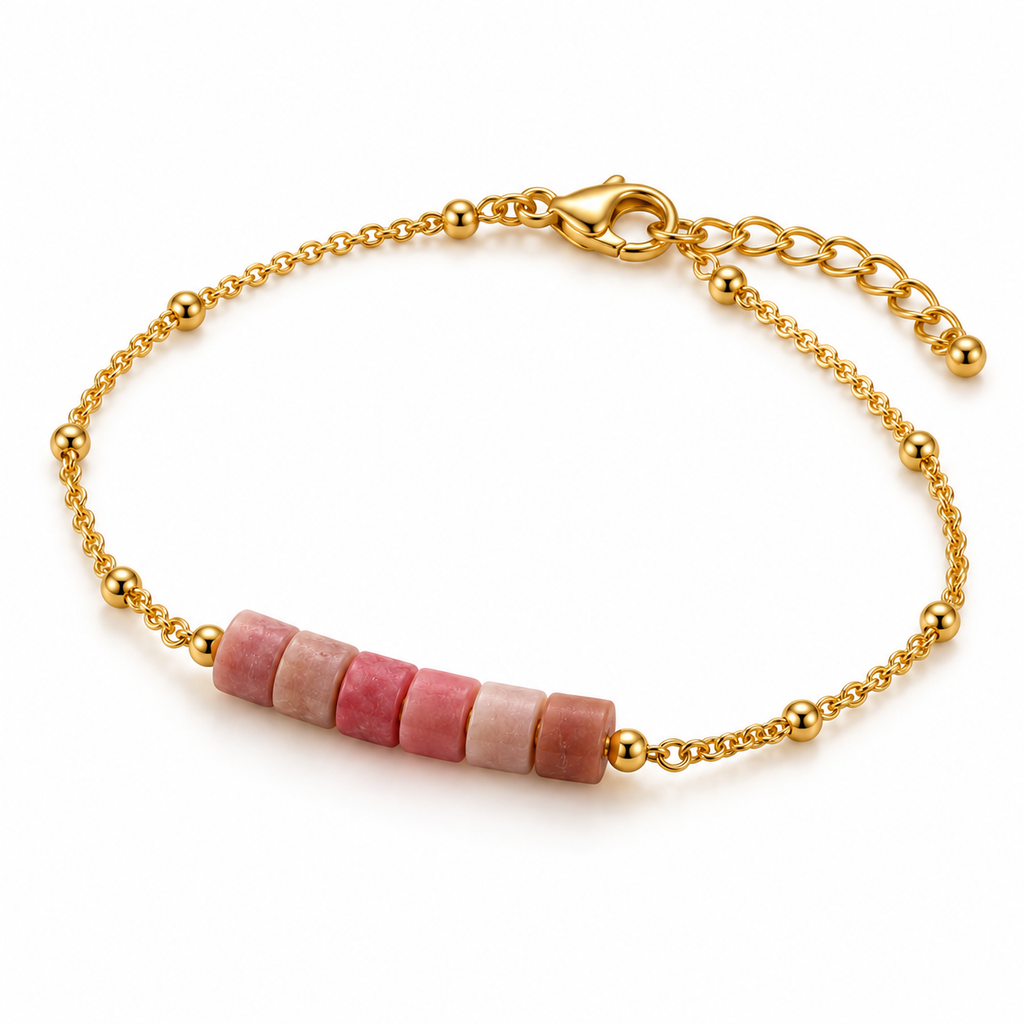 Overhead product flat lay of the pink rhodonite cylinder bead bar bracelet showing the adjustable extender chain and polished gold beads.

