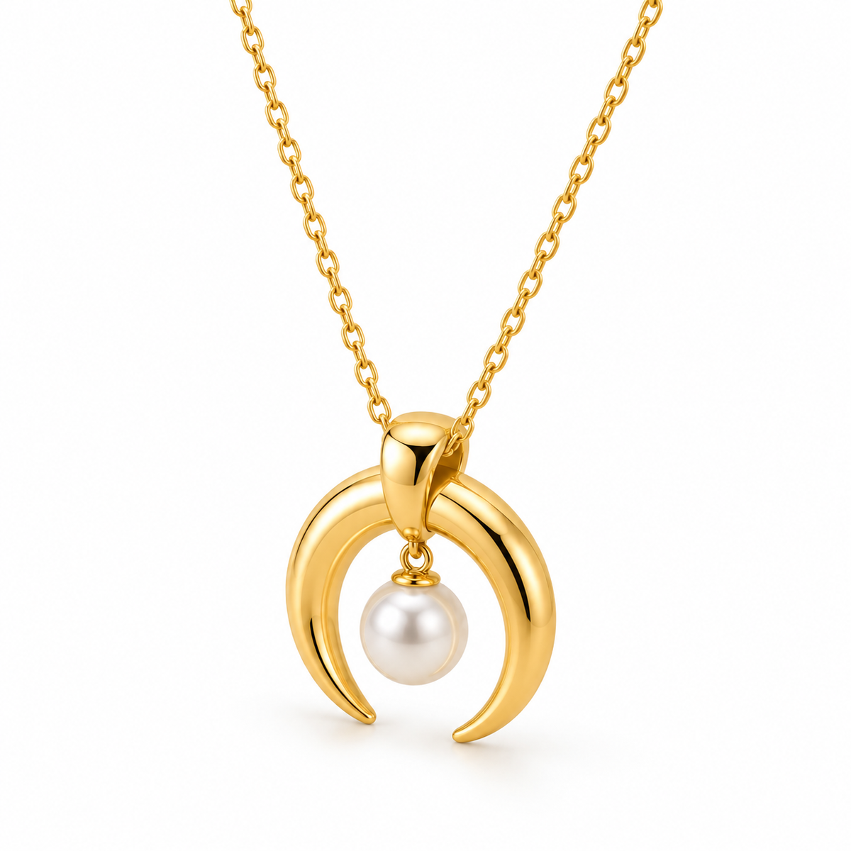 Detailed macro view of polished gold crescent double horn charm holding lustrous round pearl drop
