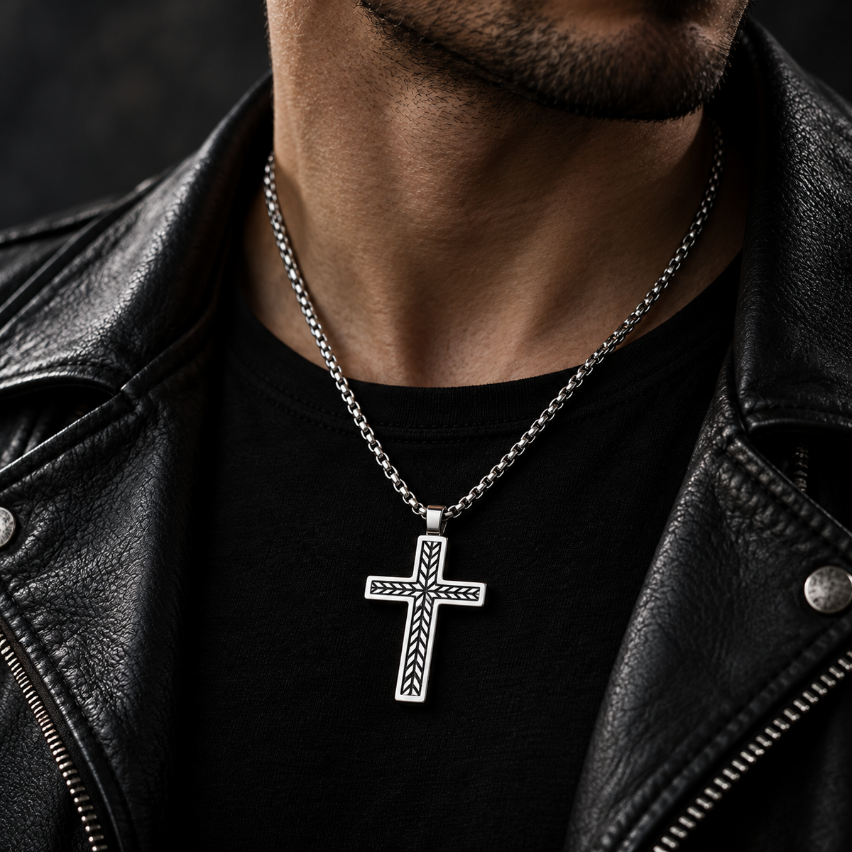 Model wearing men's silver chevron cross pendant necklace with black leather biker jacket
