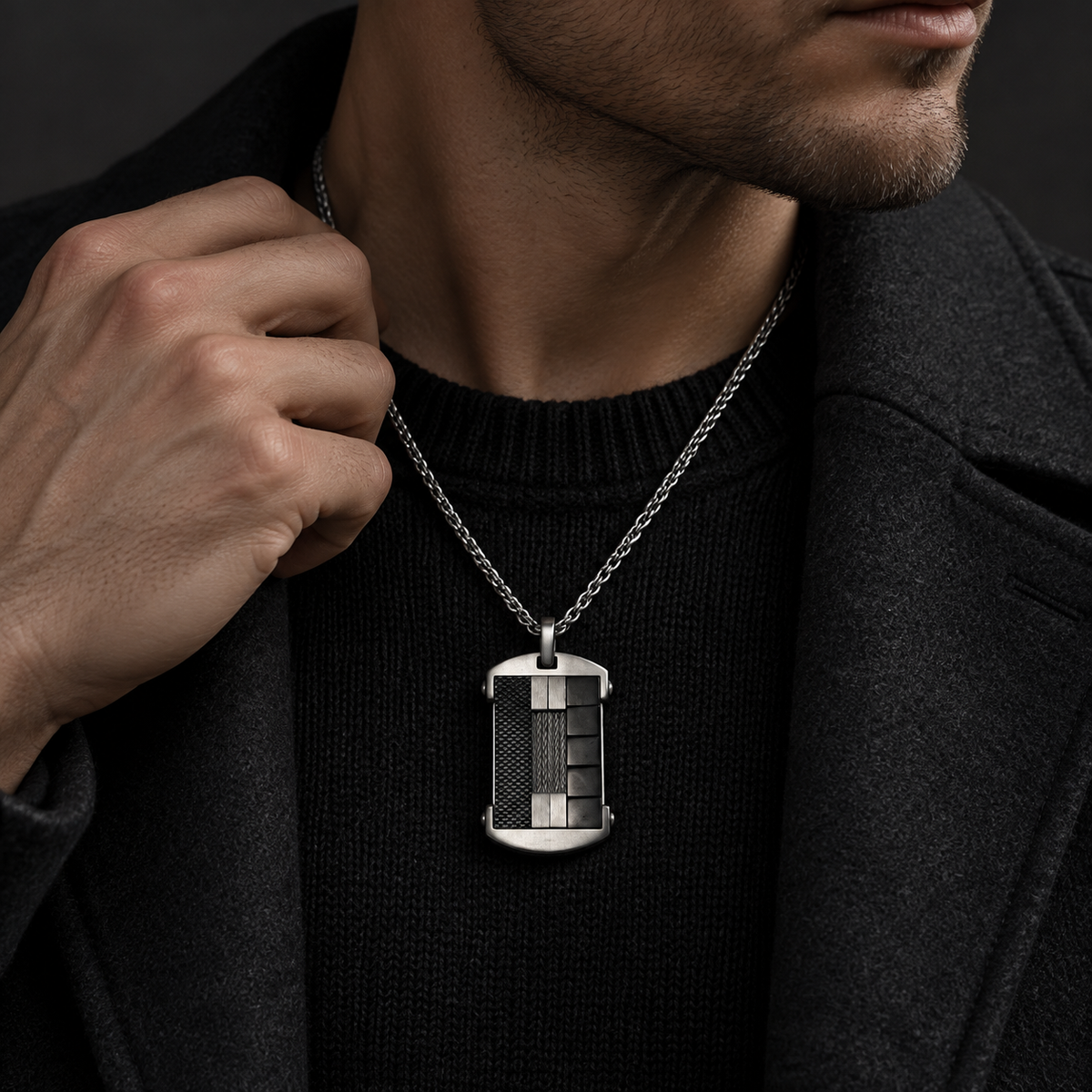 Model wearing men's industrial mixed-material dog tag necklace with black wool coat
