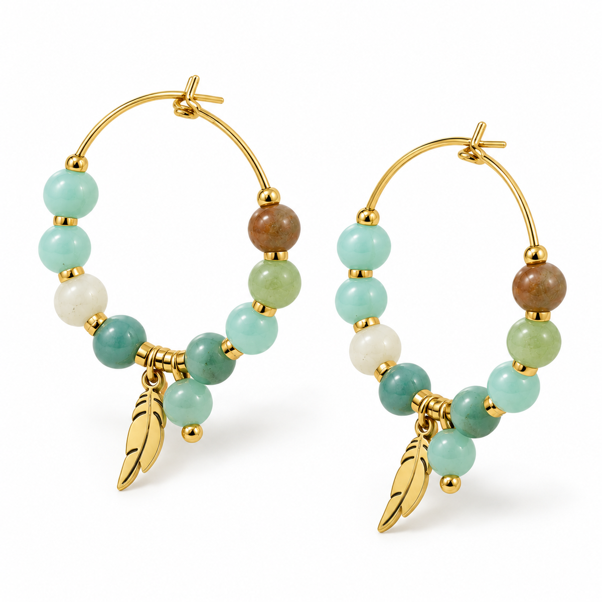 Angled studio shot of two gold plated stainless steel hoop earrings adorned with green beads and leaf feather charms
