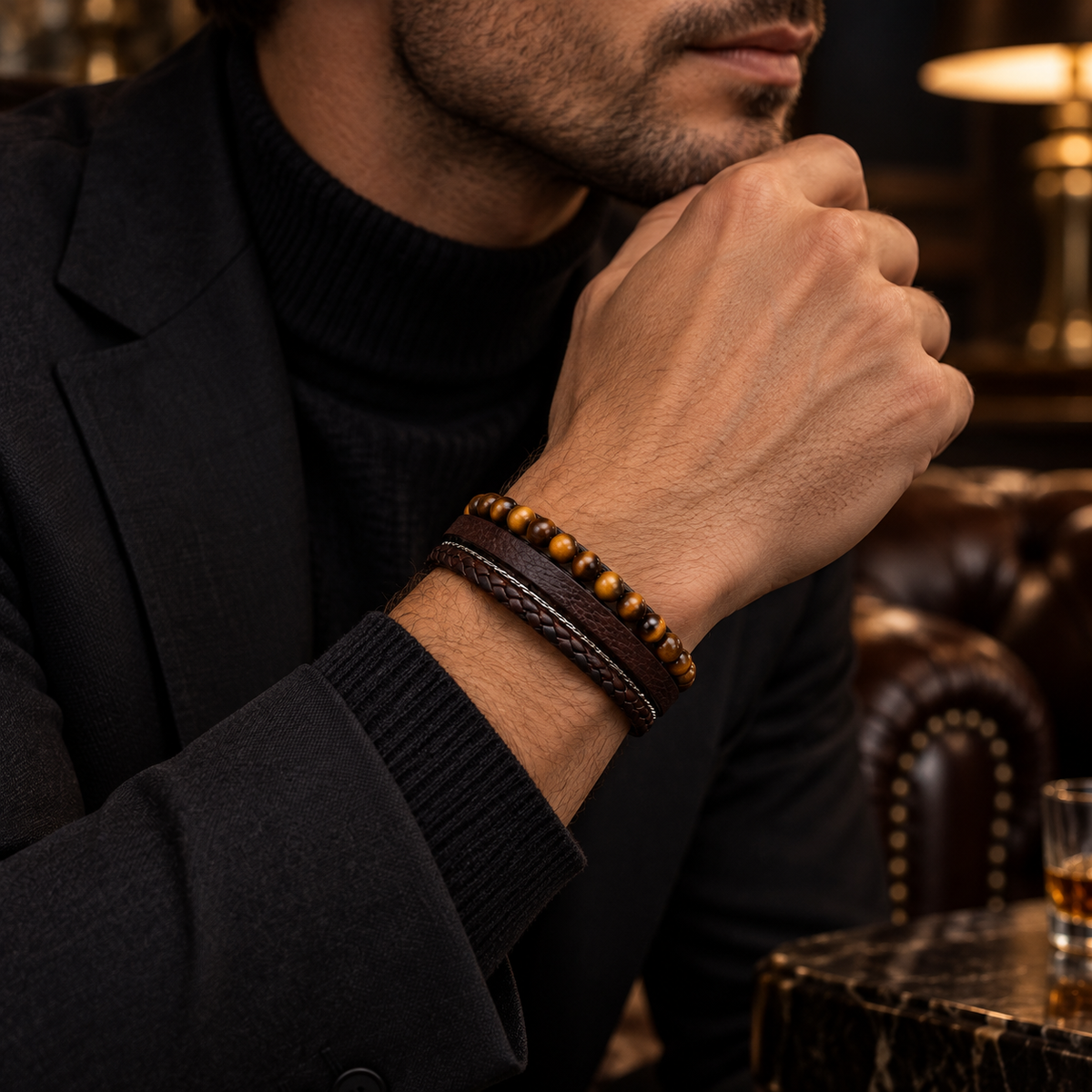 Male wrist wearing brown leather tiger eye beaded bracelet paired with black turtleneck
