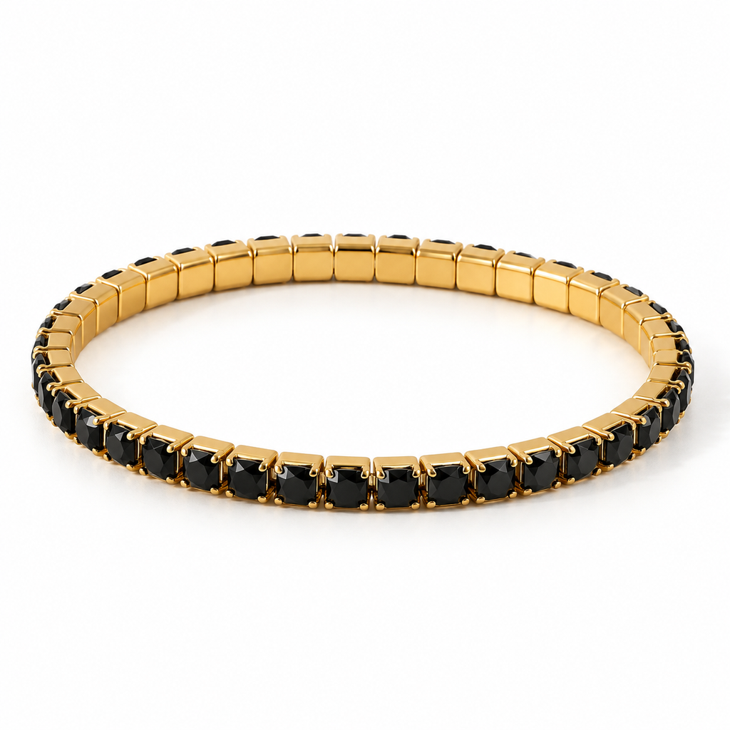Lifestyle wrist shot of the square black gemstone stretch bracelet in warm natural sunlight paired with a chic neutral outfit.
