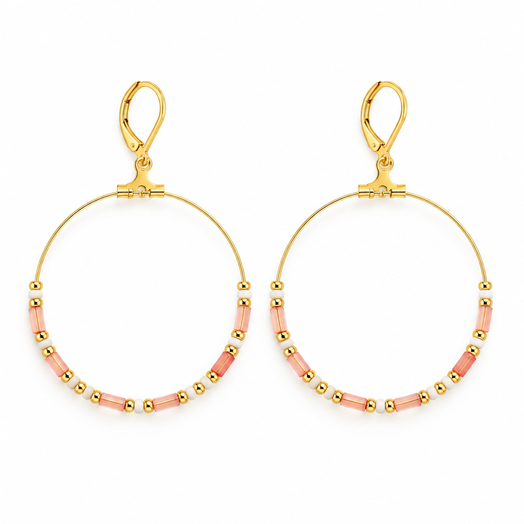 Pair of women's boho large gold hoop earrings with pastel pink tube beads and leverback clasps on white background
