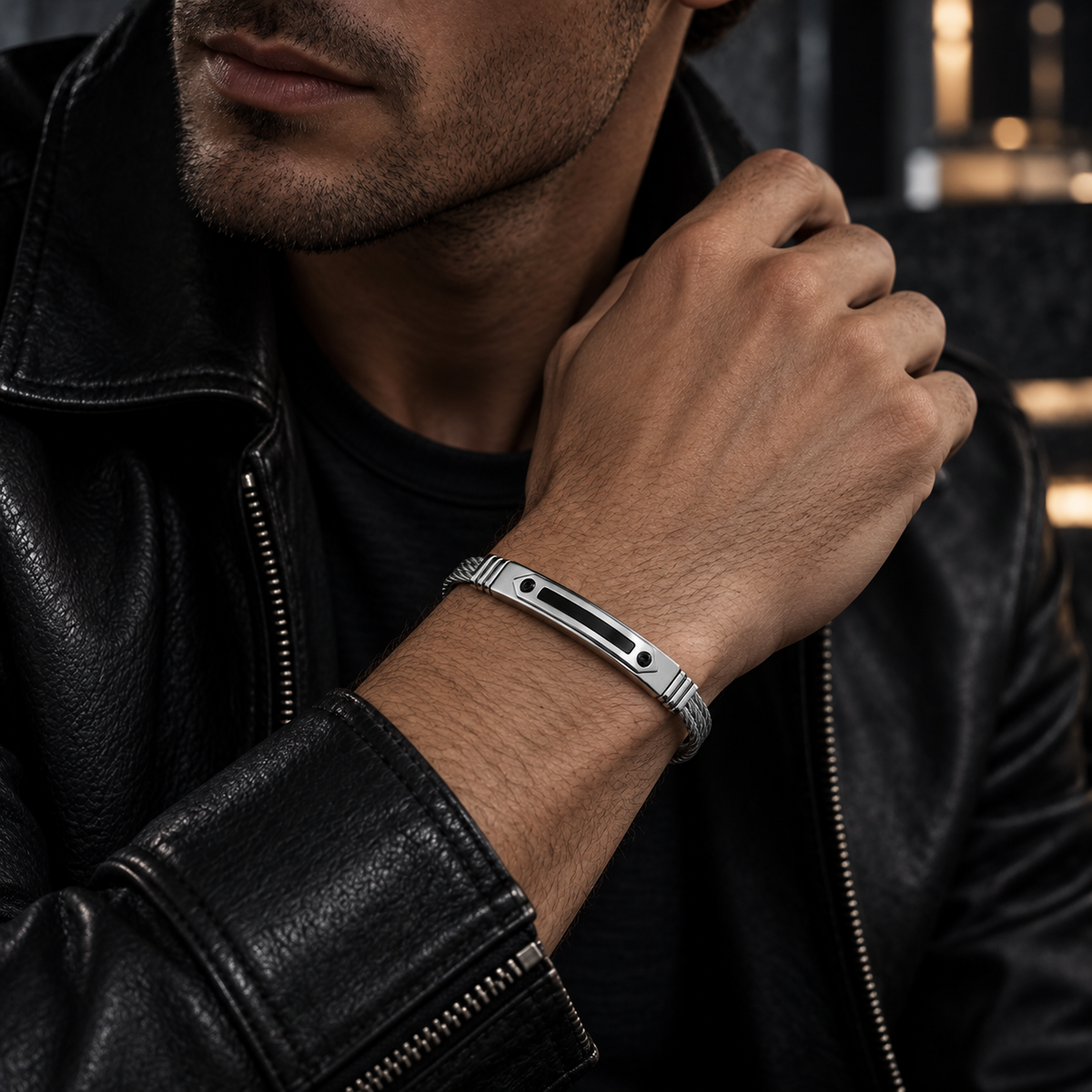 Model wearing men's steel cable arrowhead black CZ bracelet with black leather jacket
