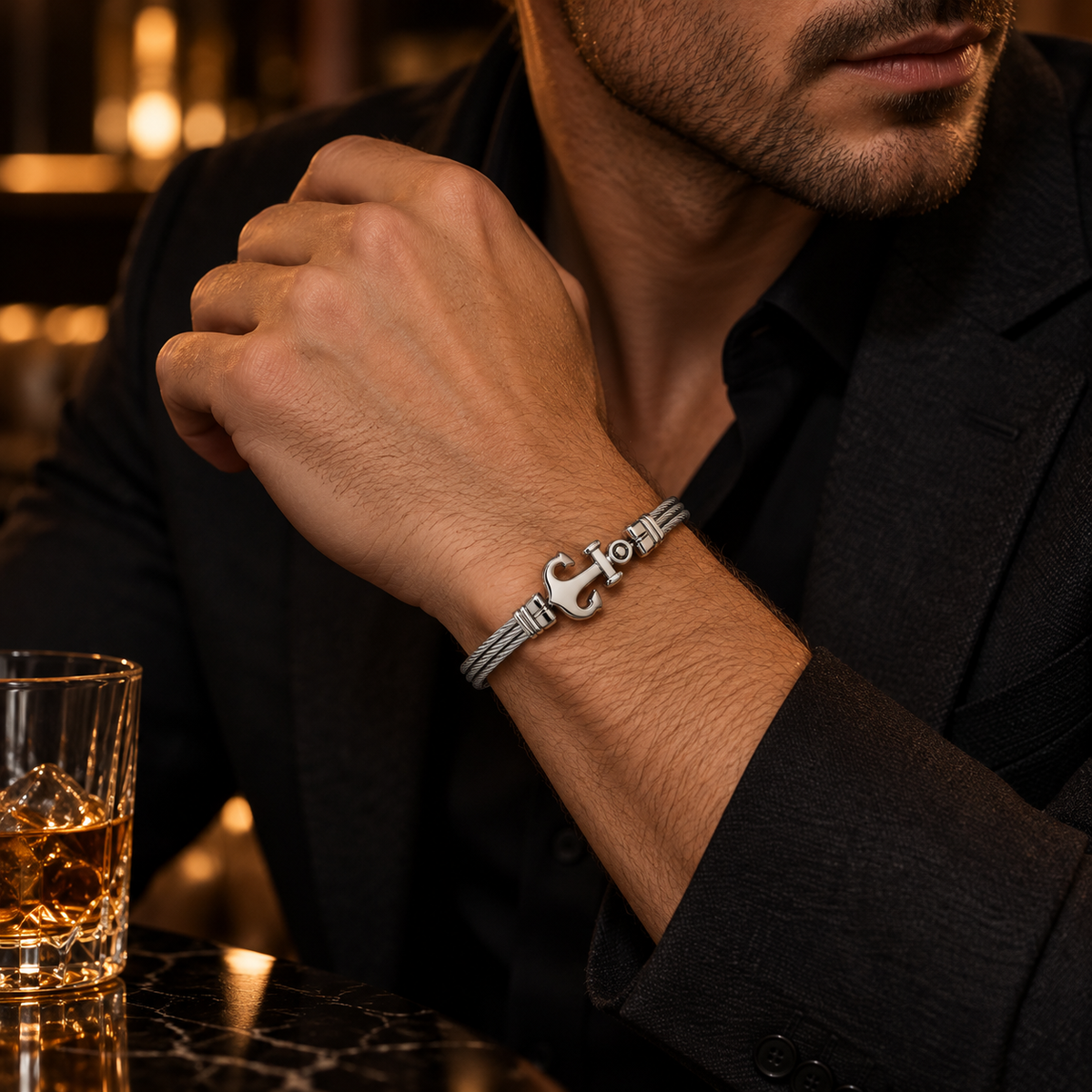 Model wearing men's stainless steel anchor wire cable bracelet with formal black suit
