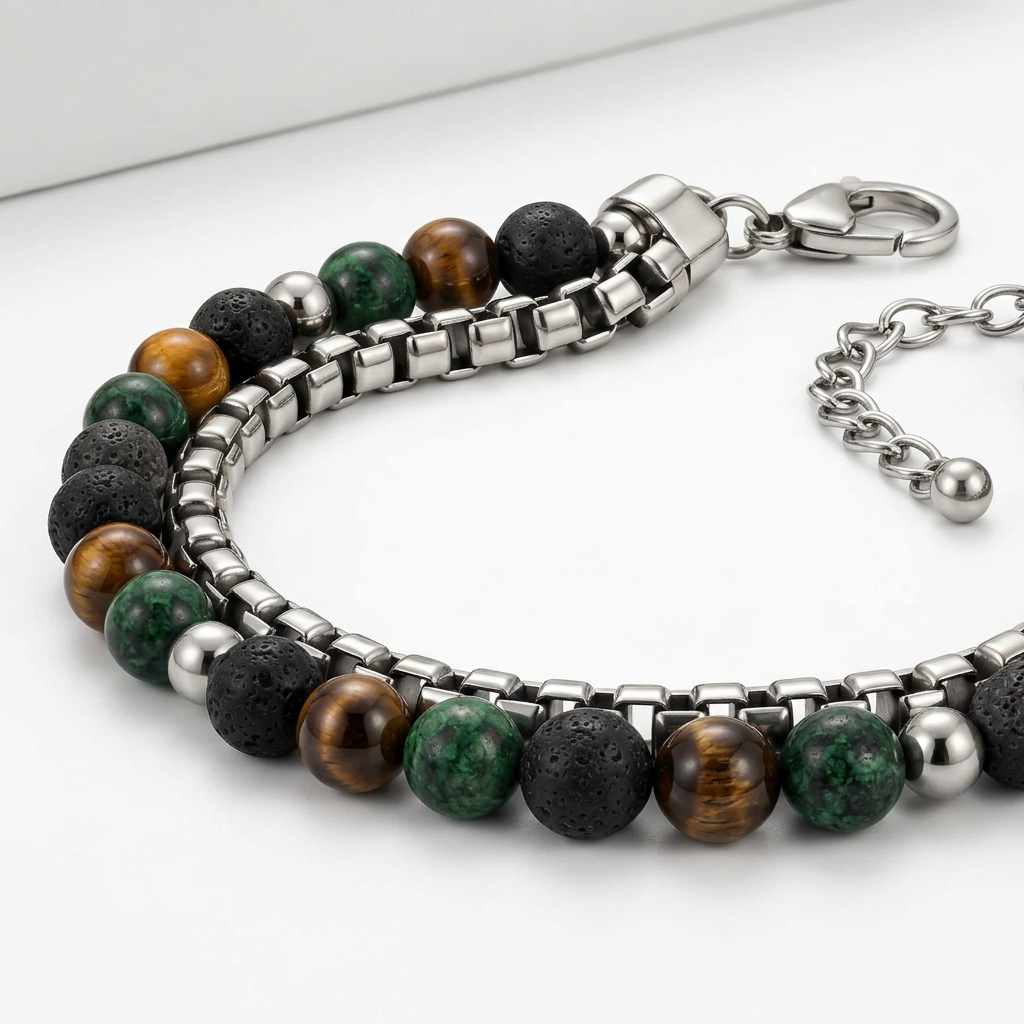 Macro studio detail of stainless steel box chain, lava beads, and lobster clasp
