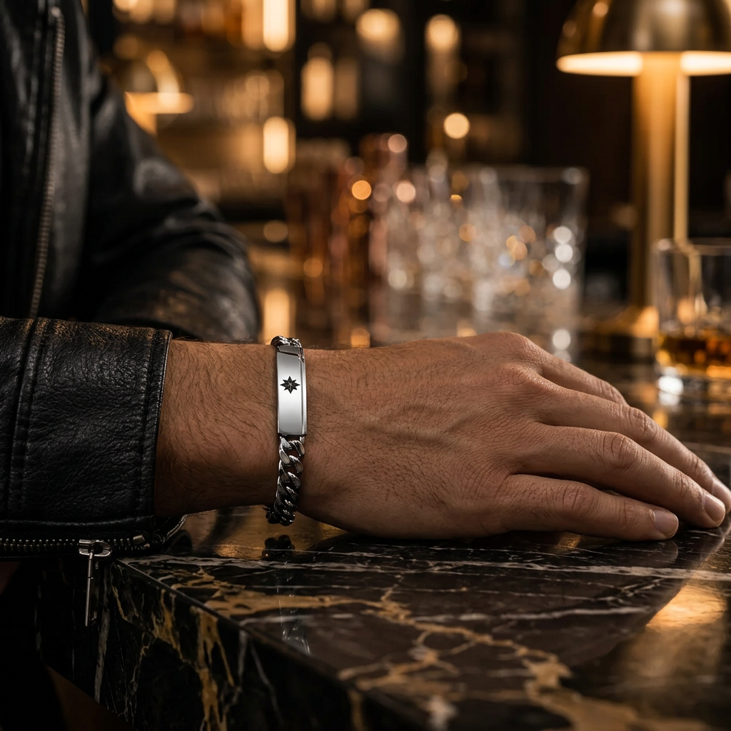 Close-up wrist view of men's Cuban chain North Star bracelet on marble counter
