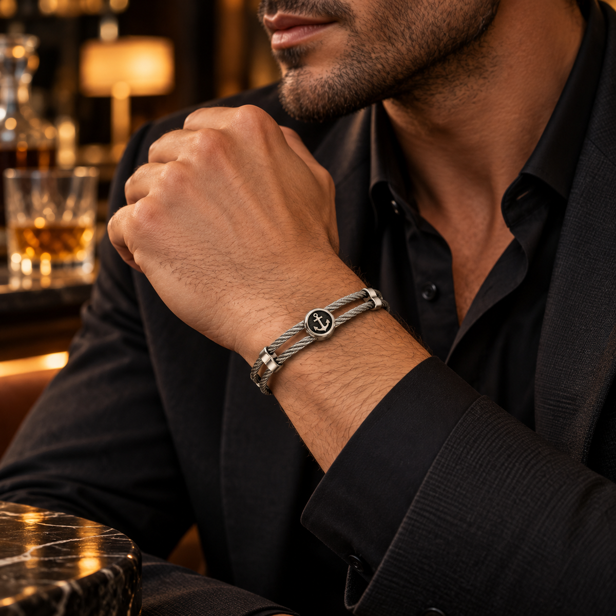 Model wearing men's stainless steel anchor coin wire cable bracelet with formal black suit
