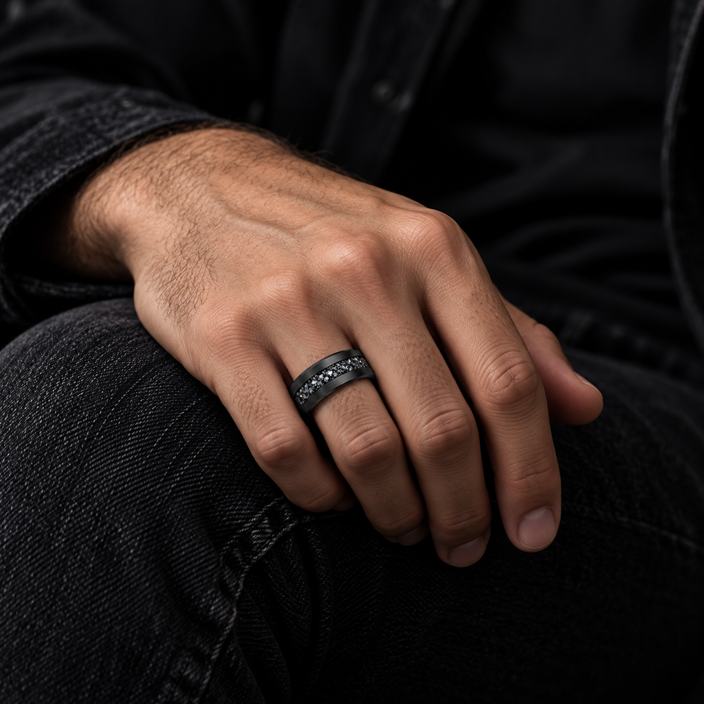 Male hand resting on denim jeans wearing brushed black crystal channel ring
