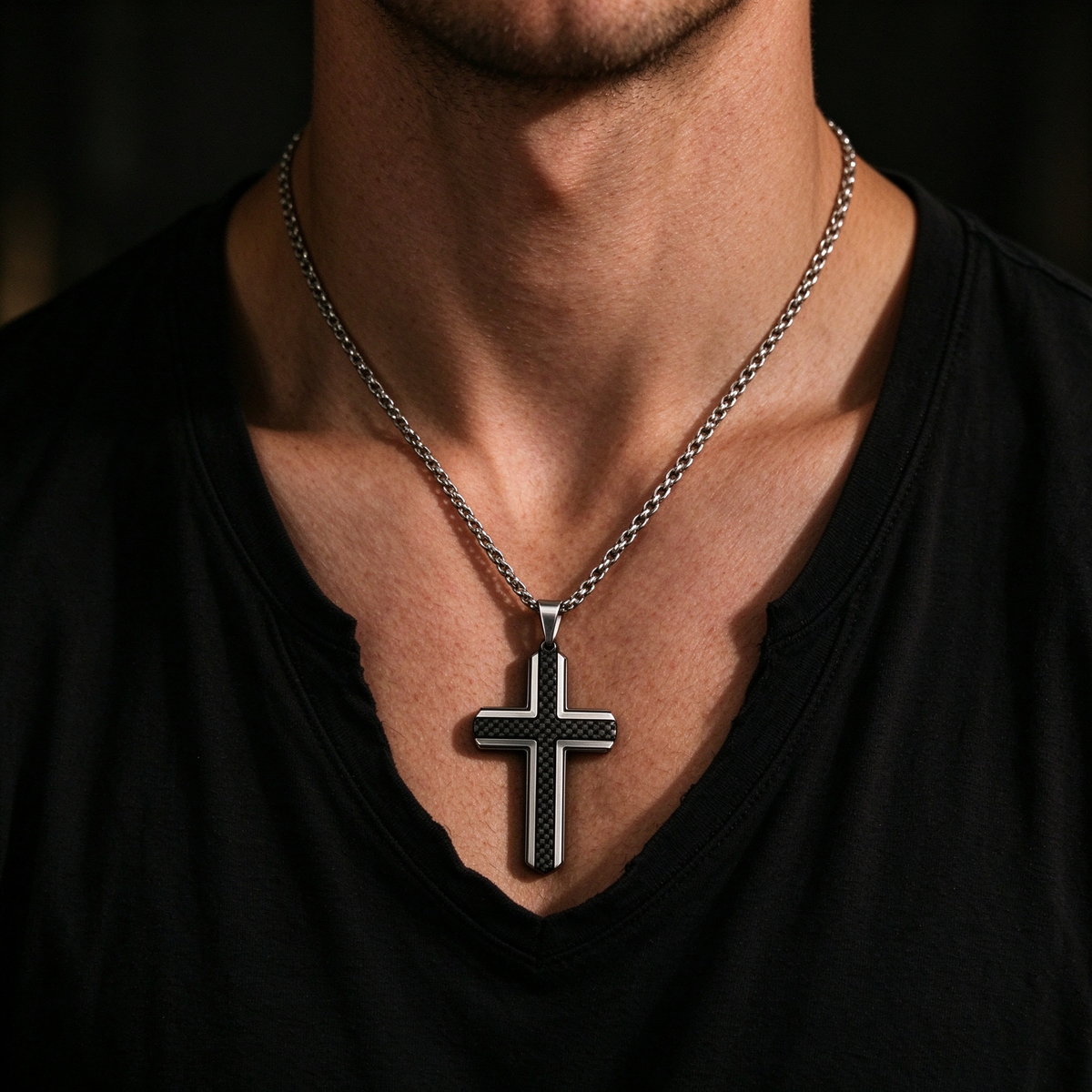 Model wearing men's black carbon fiber grid cross pendant necklace on dark chain

