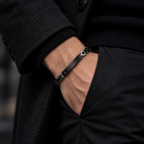 Model wearing men's all-black motorcycle chain bracelet with hand in pocket
