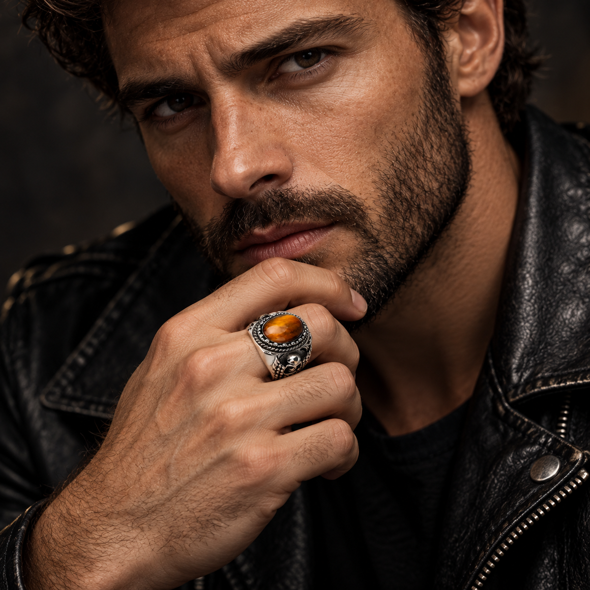 Model wearing men's gothic skull tiger eye statement ring on finger
