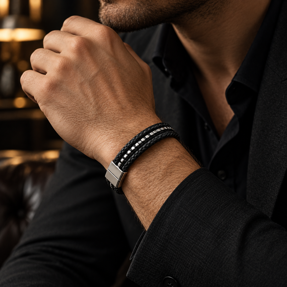 Gentleman in black suit touching chin wearing Men's silver beaded leather cuff bracelet
