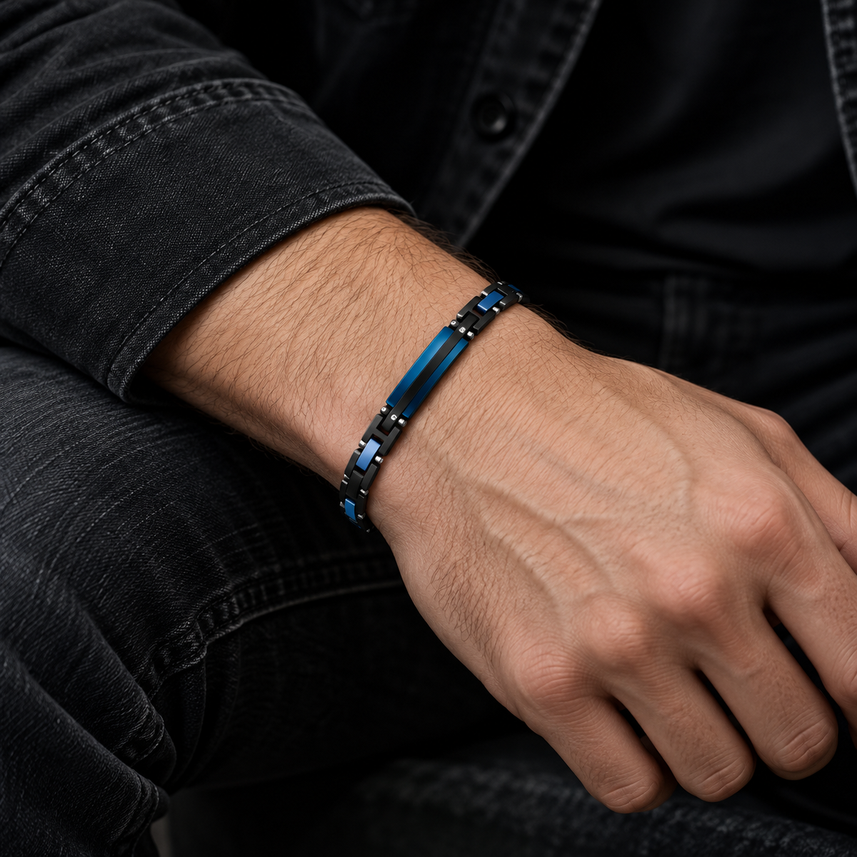Model wearing men's black and blue link ID bracelet with black denim jacket
