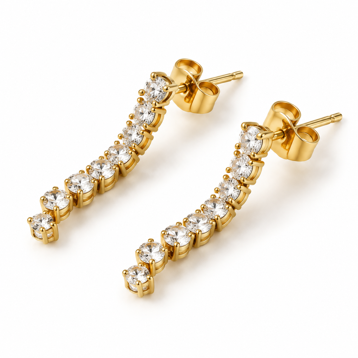 Pair of women's curved gold tennis bar stud earrings with sparkling round cubic zirconia stones on white background
