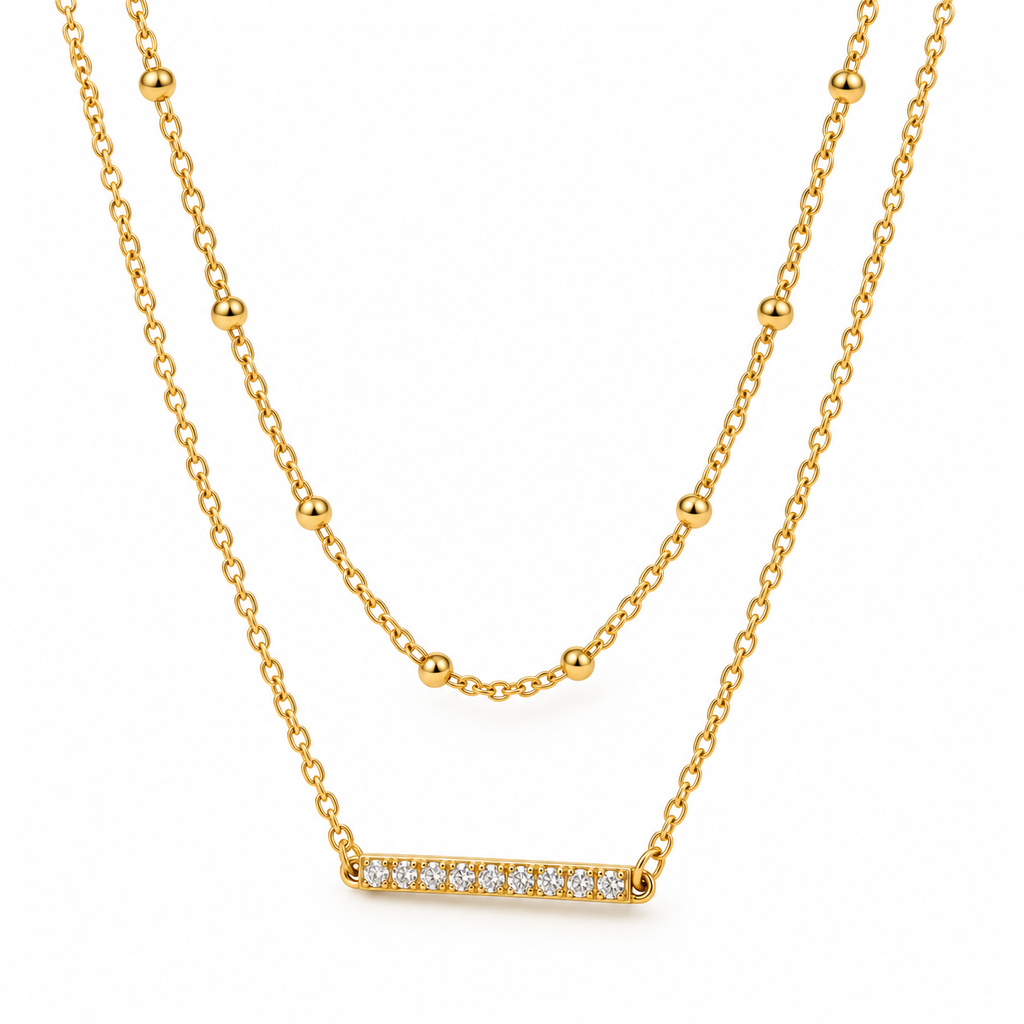 Dainty 2-in-1 gold satellite beaded choker and sparkling crystal bar pendant necklace flat lay
