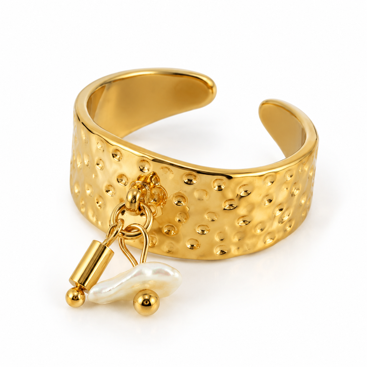 Studio flat lay of wide hammered open cuff ring with natural baroque pearl drop charm
