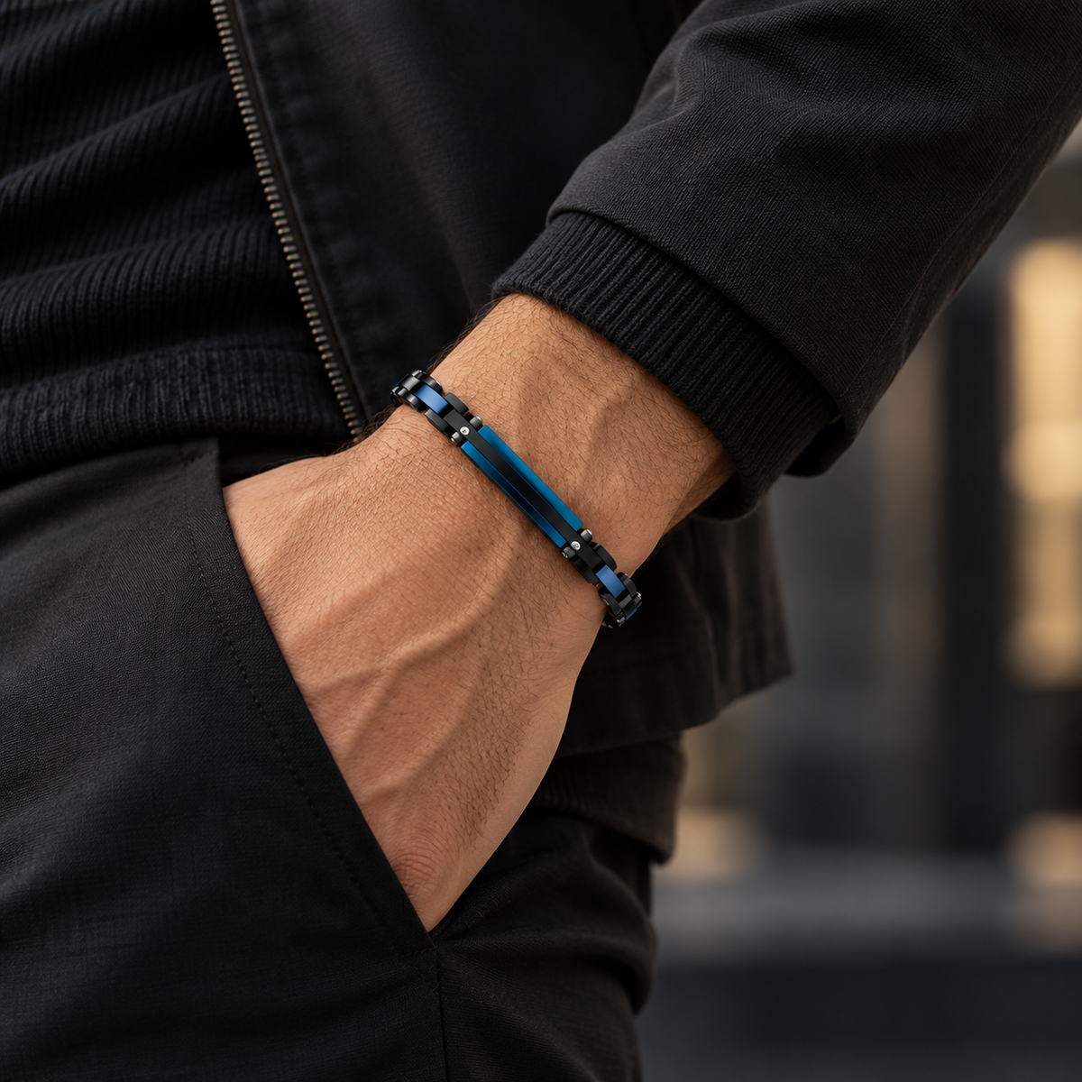 Model wearing men's blue and black link bracelet with hand in pocket
