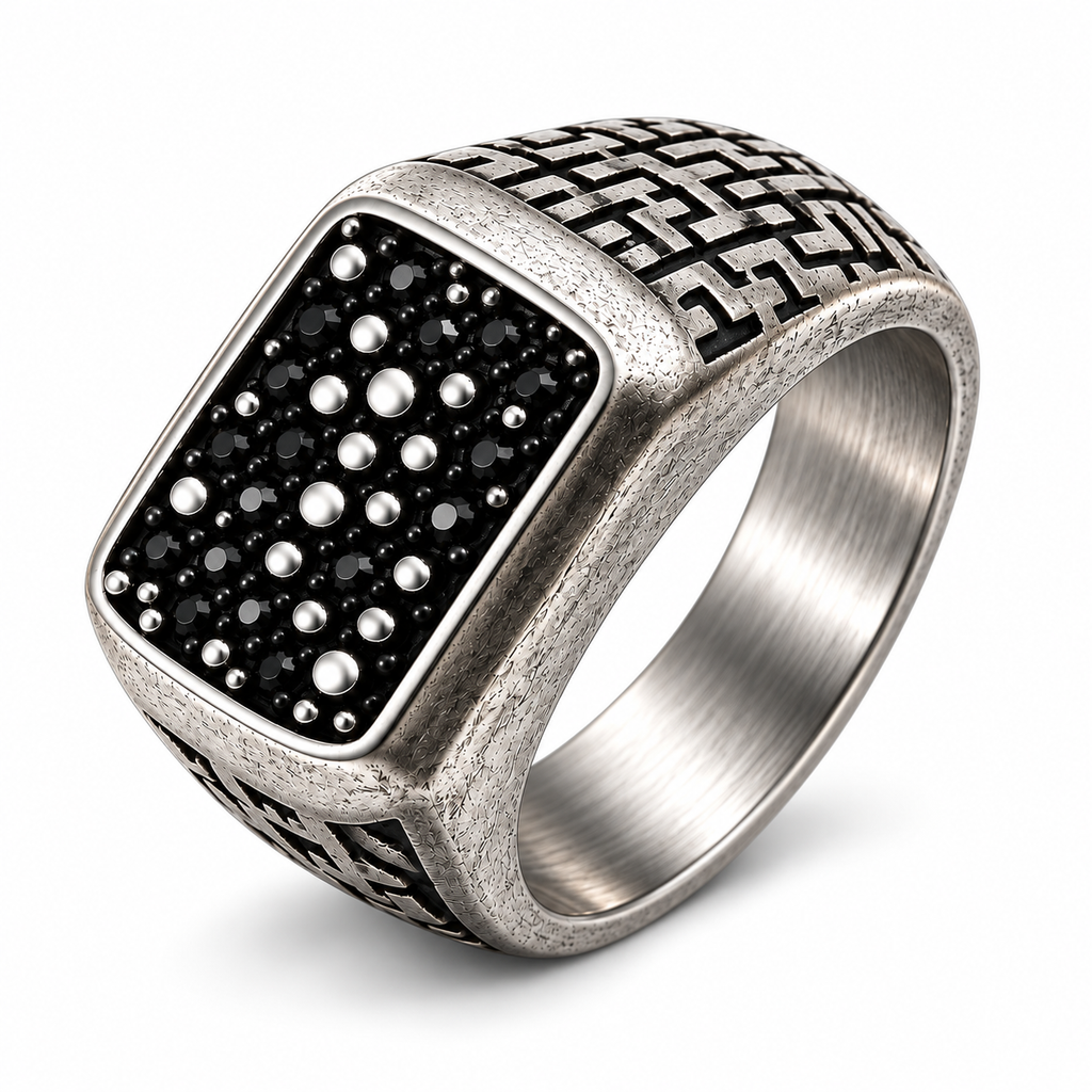 Side profile of geometric maze cutouts on antique silver signet ring
