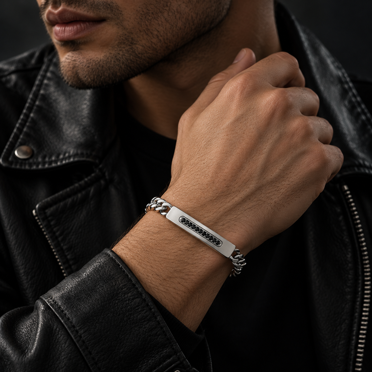 Model wearing men's steel channel-set black CZ ID bracelet with black leather jacket
