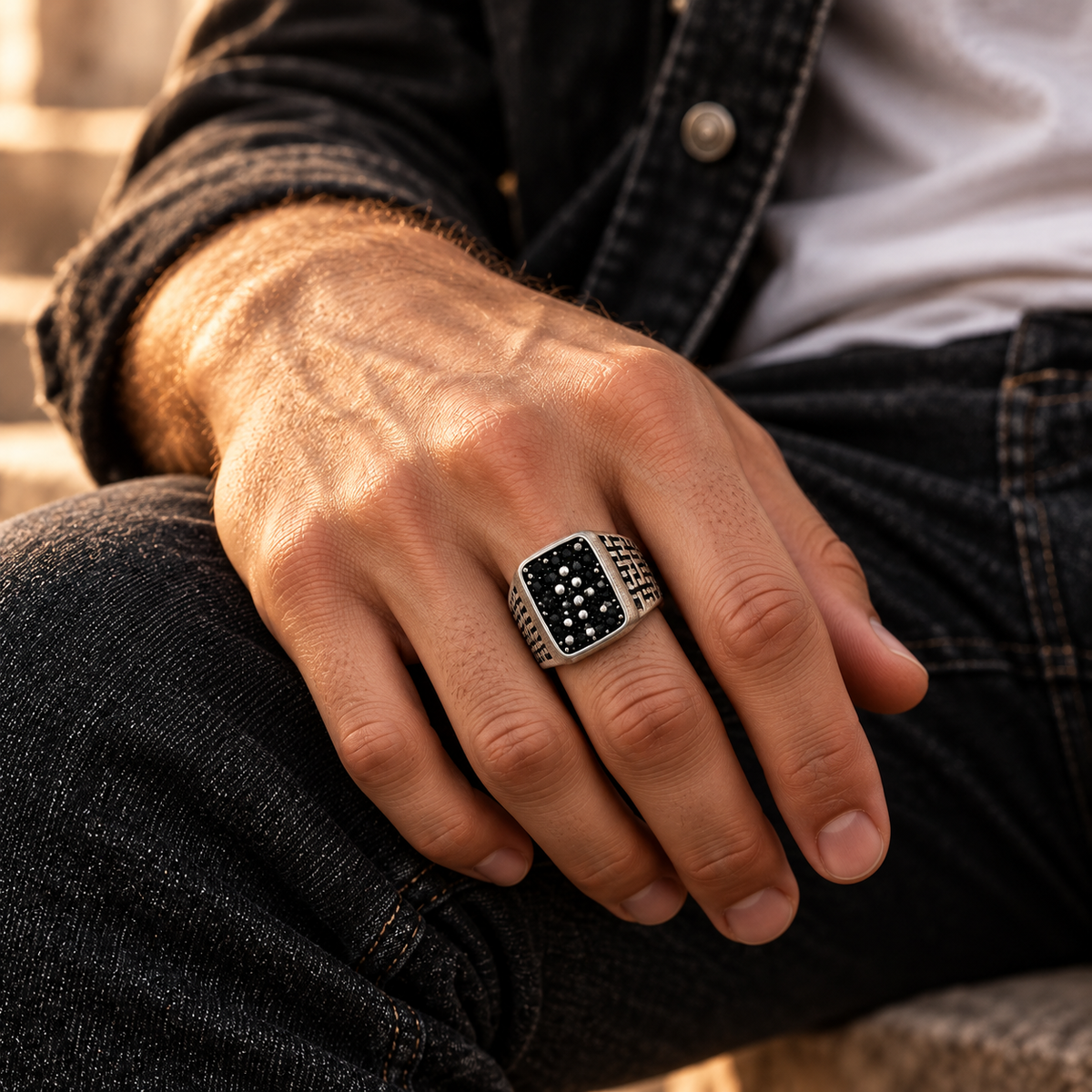 Model wearing geometric labyrinth black stone statement ring on hand
