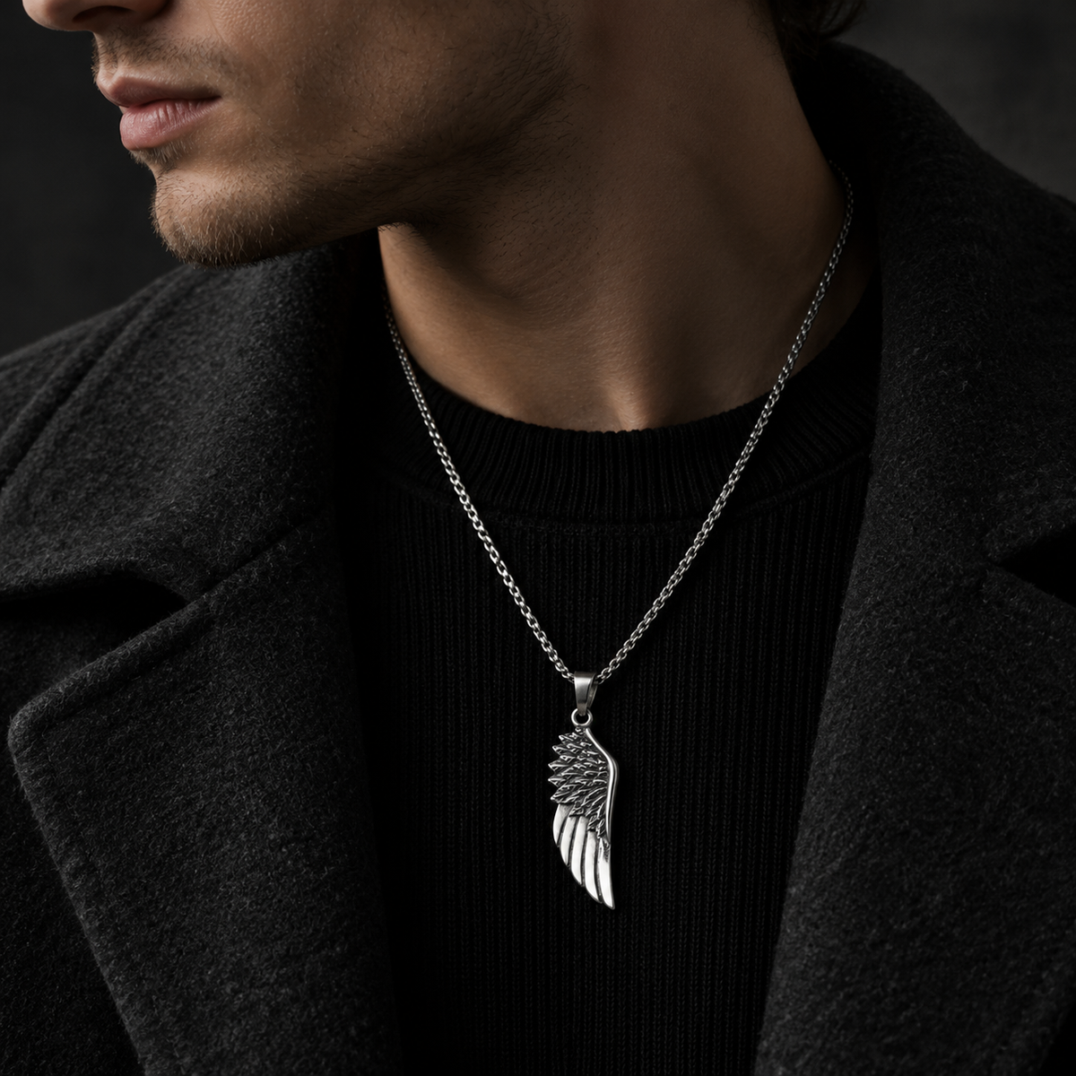 Model wearing men's stainless steel angel wing pendant necklace with black wool coat
