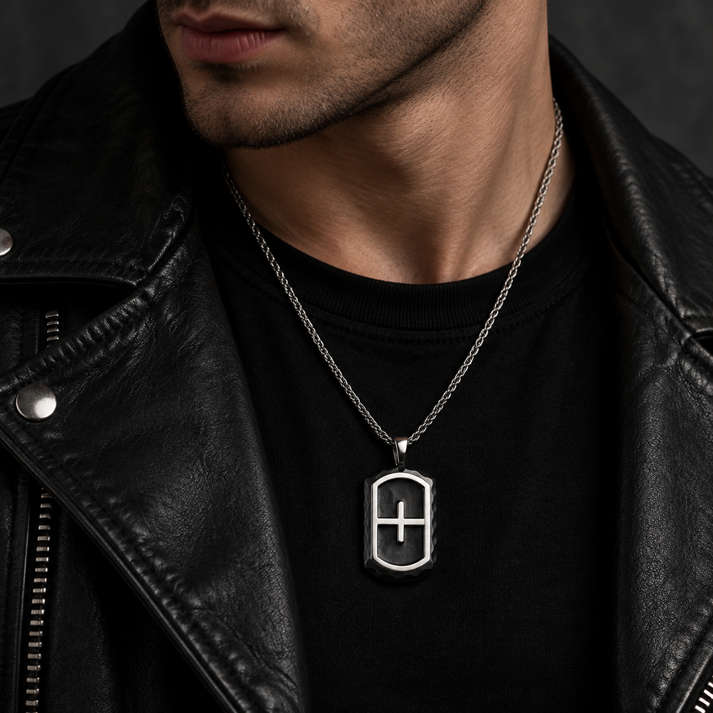 Model wearing men's black chiseled cross shield dog tag necklace with leather biker jacket
