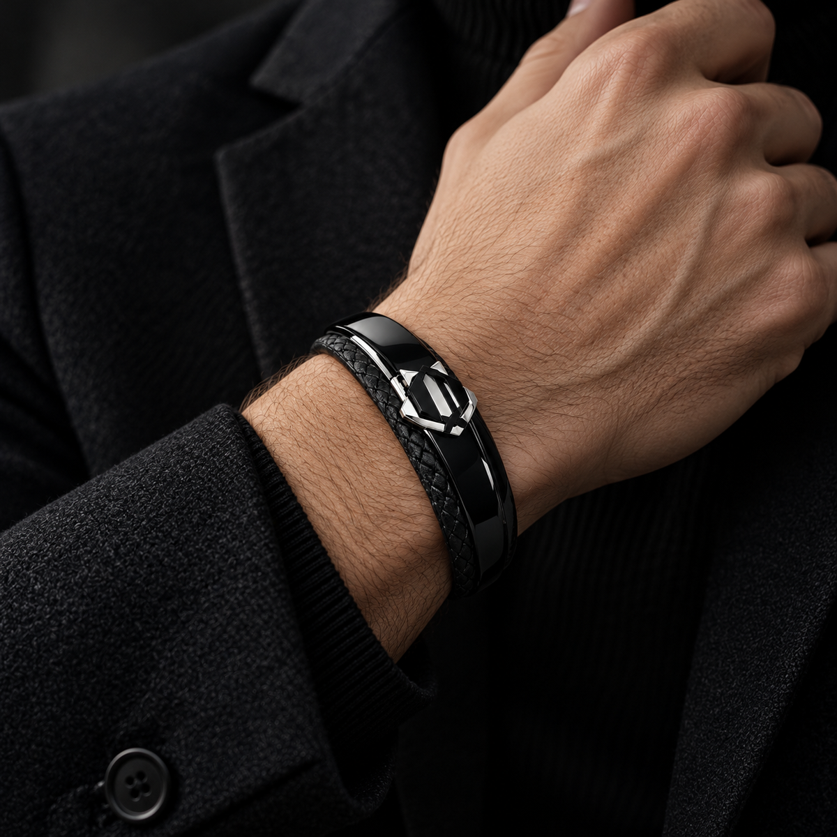 Gentleman in black wool overcoat holding wrist wearing stainless steel armor leather bracelet

