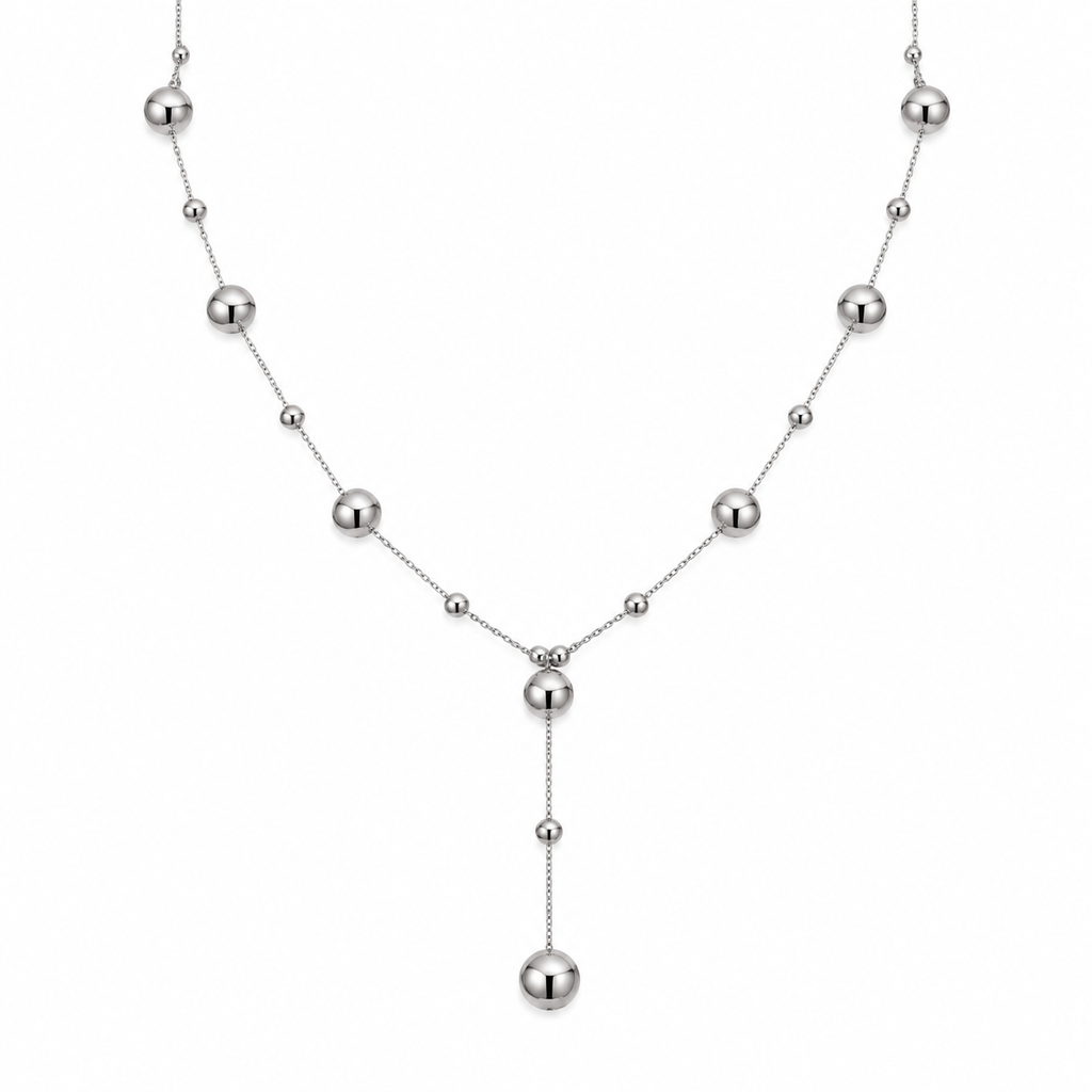 Women's polished stainless steel station ball bead lariat Y-necklace on white background
