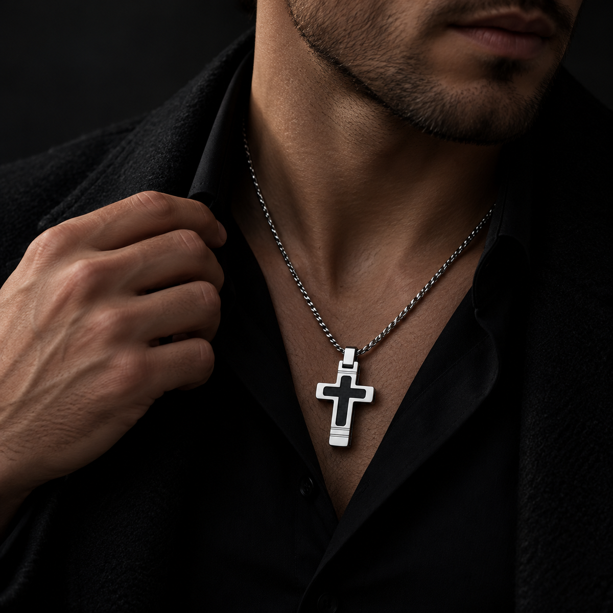 Model wearing men's architectural black cross pendant necklace with black button-down shirt
