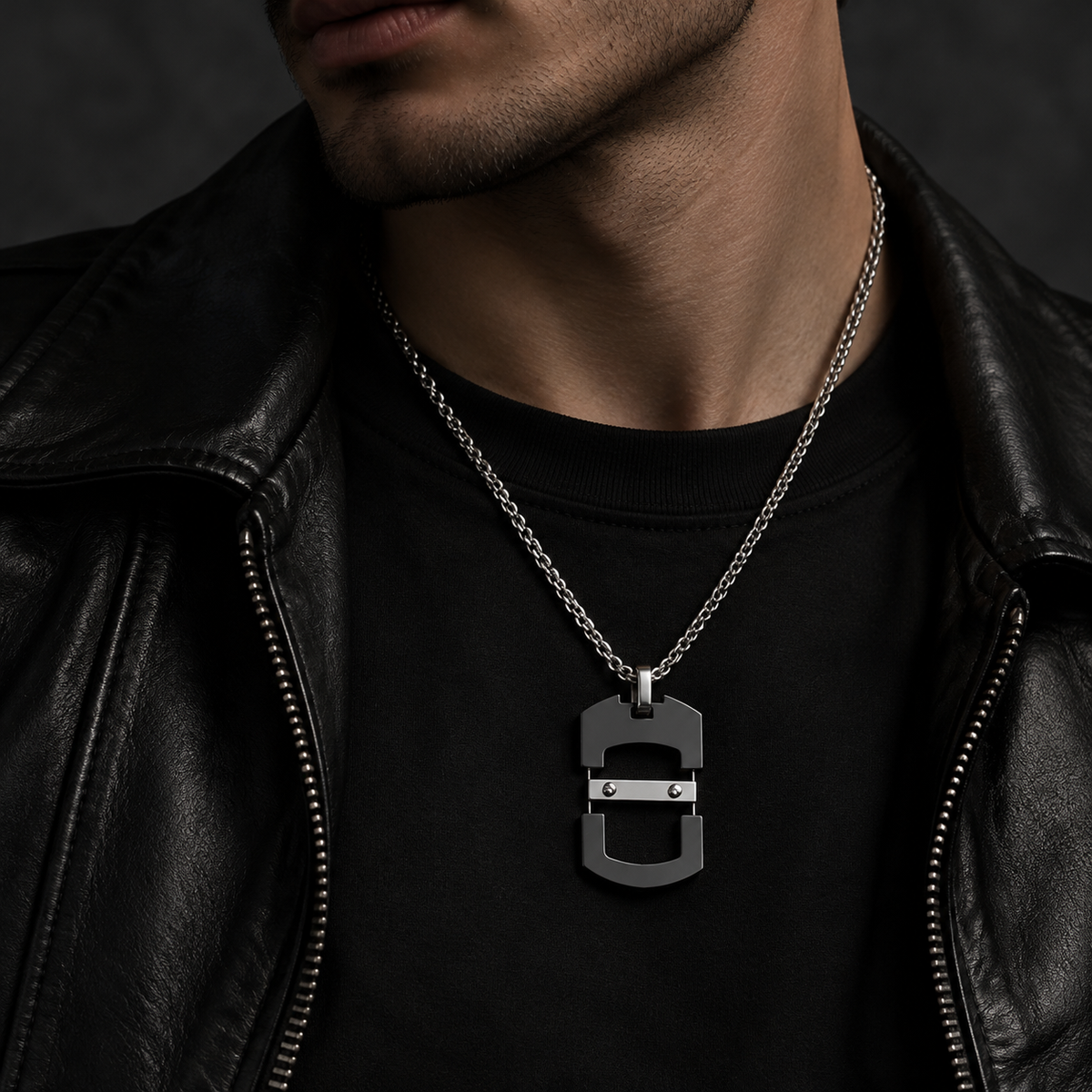 Model wearing men's matte black mechanical skeleton dog tag necklace with leather jacket
