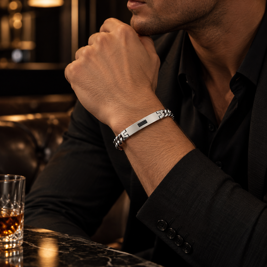 Model wearing men's stainless steel Cuban ID bracelet paired with black formal suit
